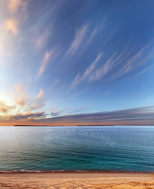 Looking out over the Manitou Islands near sunset with whispy clouds overhead