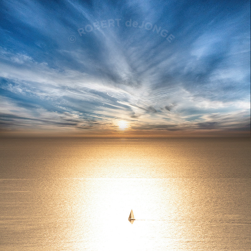 Sailboat moving through the golden waters near sunset. Images from the Pierce Stocking Scenic Overlook on Lake Michigan, Sunset sky