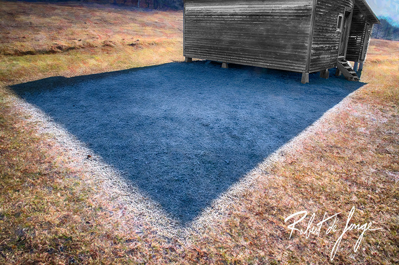 The shadow of an outbuilding on a  Port Oneida homestead protects the ground frost