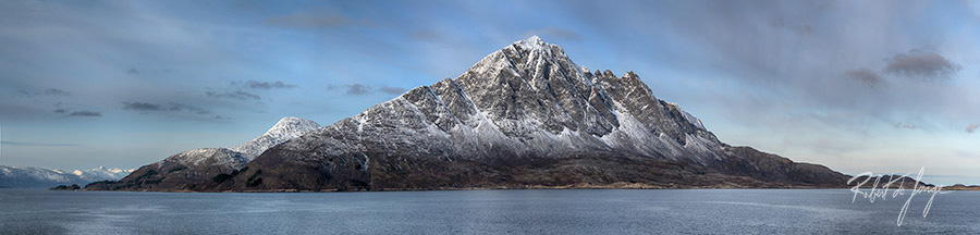Snow frosts the pyramid peak off the coast of Norway