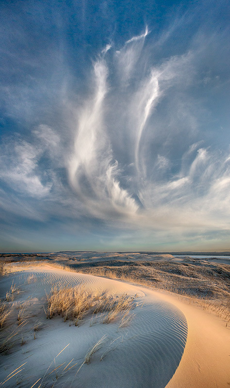 The sky mimics the earth on the dunes