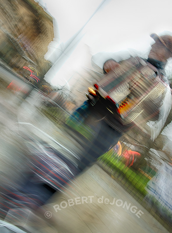 an accordian player busks in St Andrews Square
