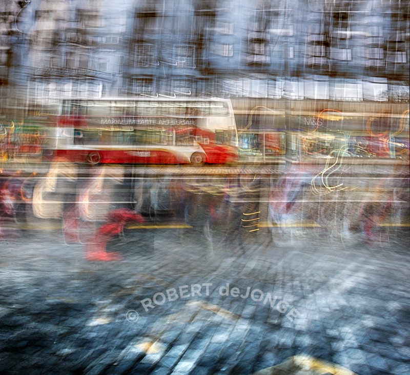 a bus makes a stop on Princes Street along the busy pre-Christmas shopping days