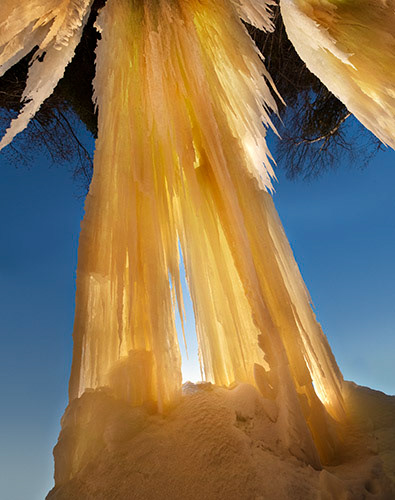 Ice cave, room, seeping water, frozen, minerals, Grand Island, limestone, Munising, Michigan, Lake Superior, iron, minerals, backlit, golden