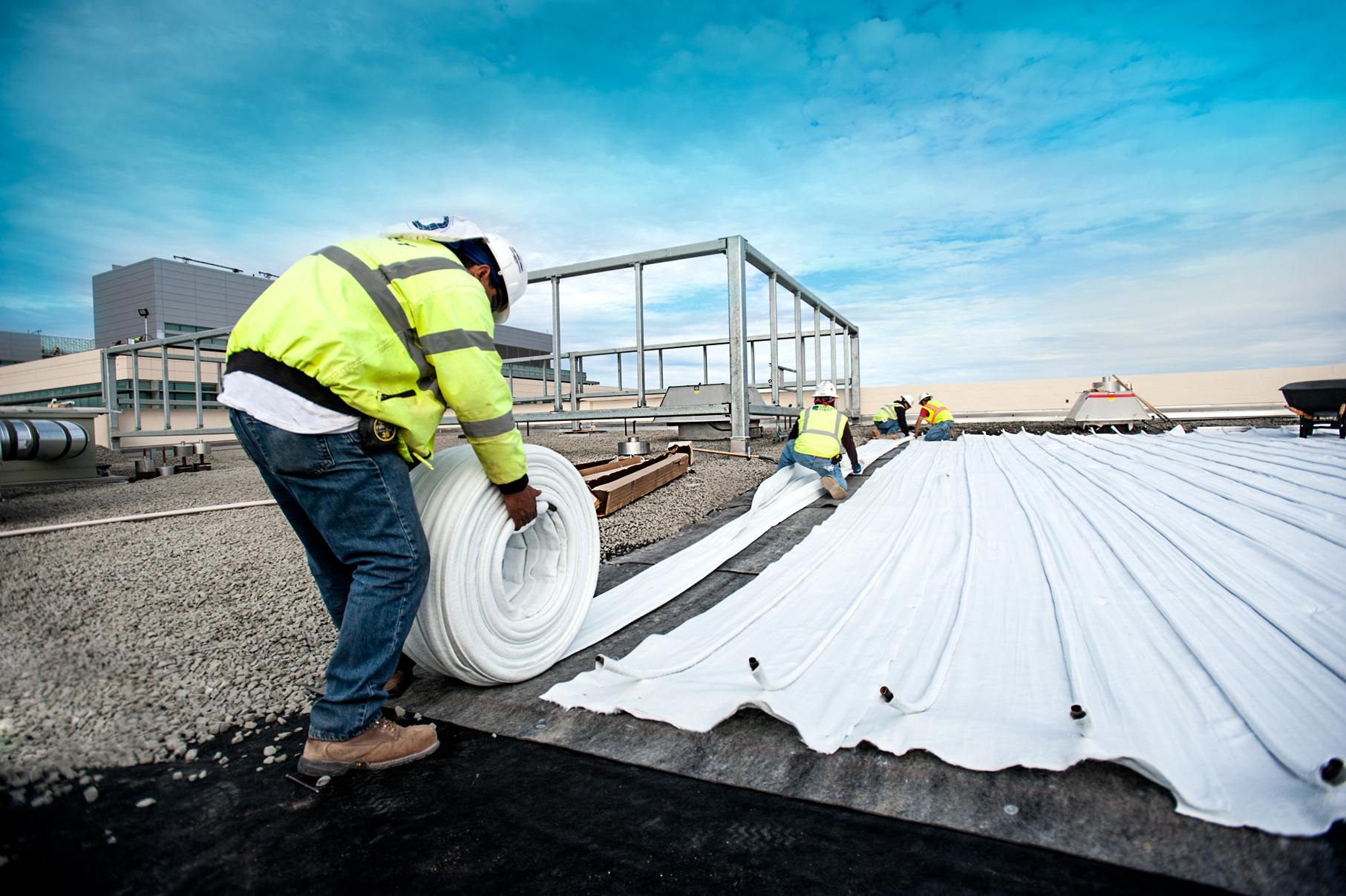 Contractors install the Hunter Industries' EcoMat on a rooftop. Image Credit: Chris Roesink