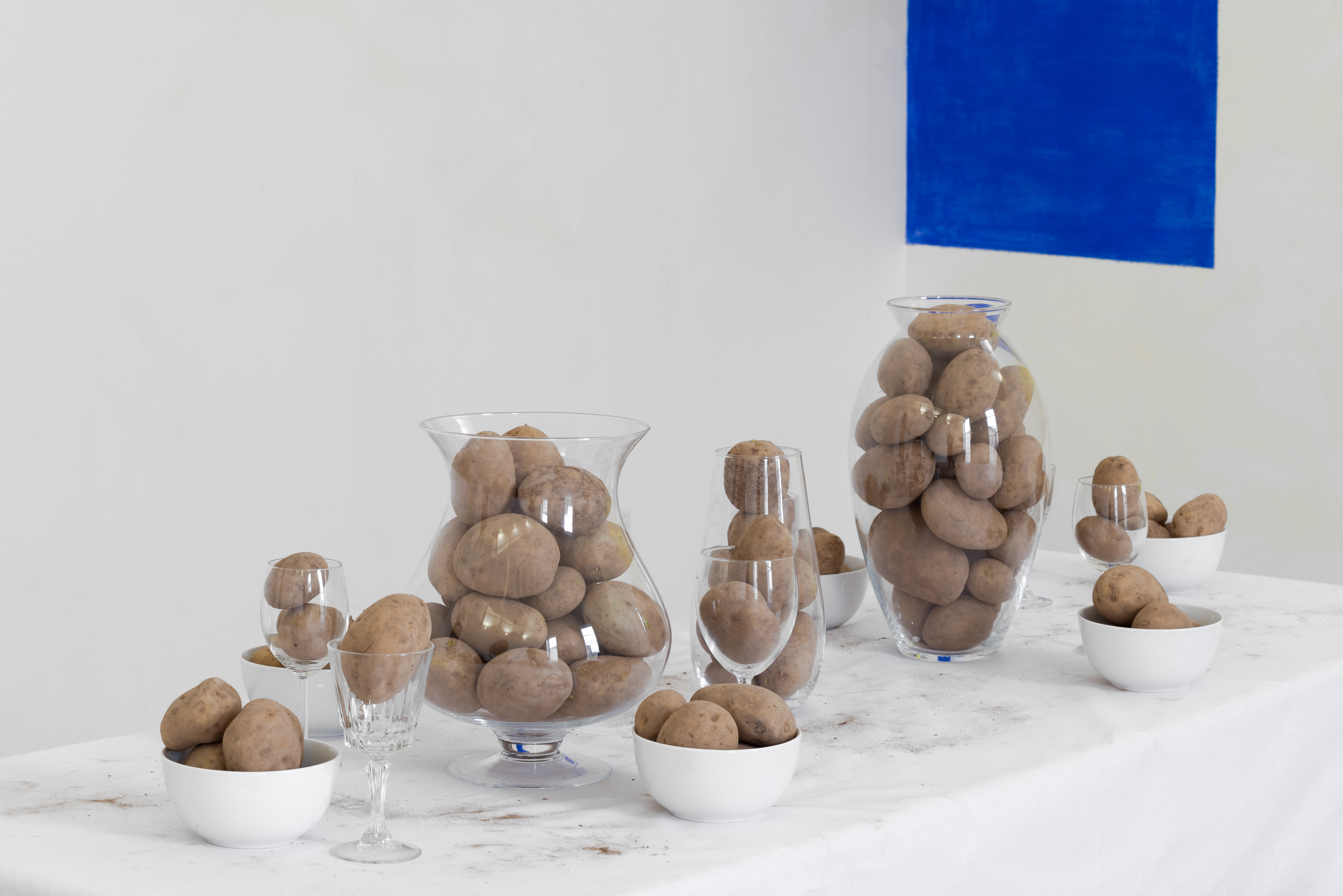 Another Exile; Christine Moldrickx by Jess Carnegie, Peter Holgate, Is van Leest, and Anna Stacey, 2016; potatoes and glass wear, table cloth, furniture; dimensions variable
