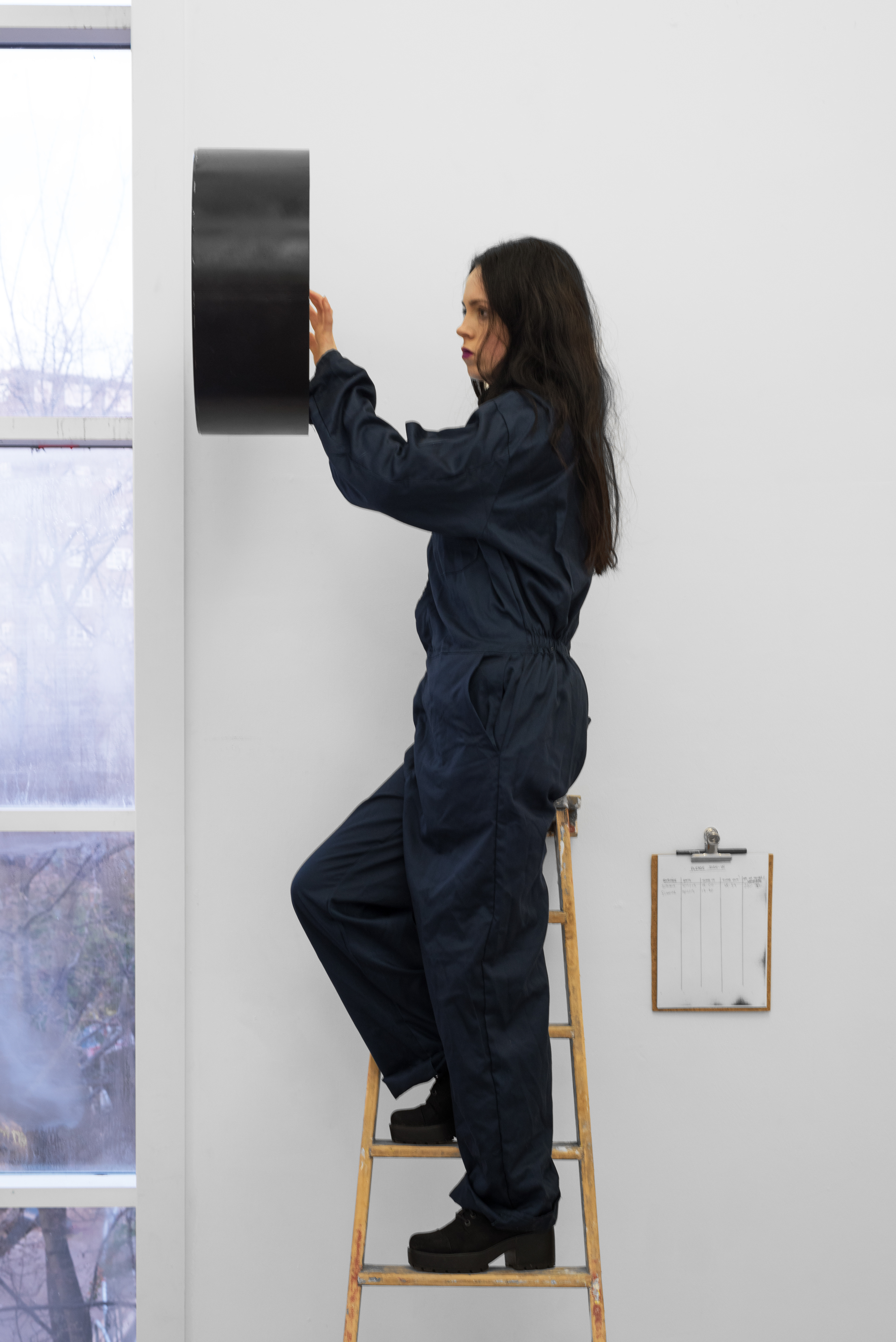 From 18:00 for two hours of the performers’ time, followed by an hour of the performers’ time beginning on the consecutive hour for the next sixteen days; Simone Barnes, 2015; performance with clock, ladder, overalls, chain and padlock