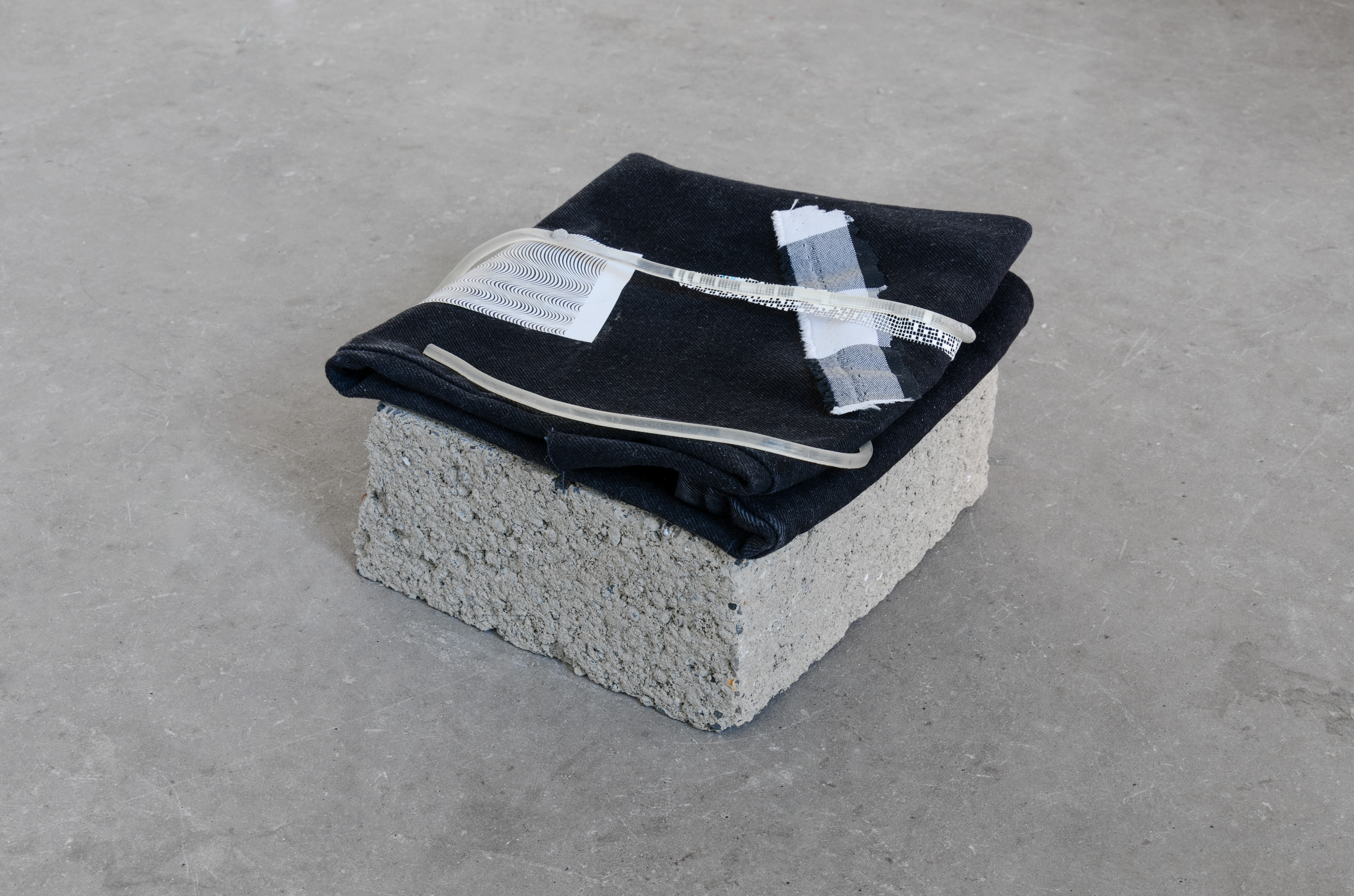 Untitled; Marianne Spurr, 2014; concrete, denim, paper, cloth, glue, branch; 14 × 23 × 30cm