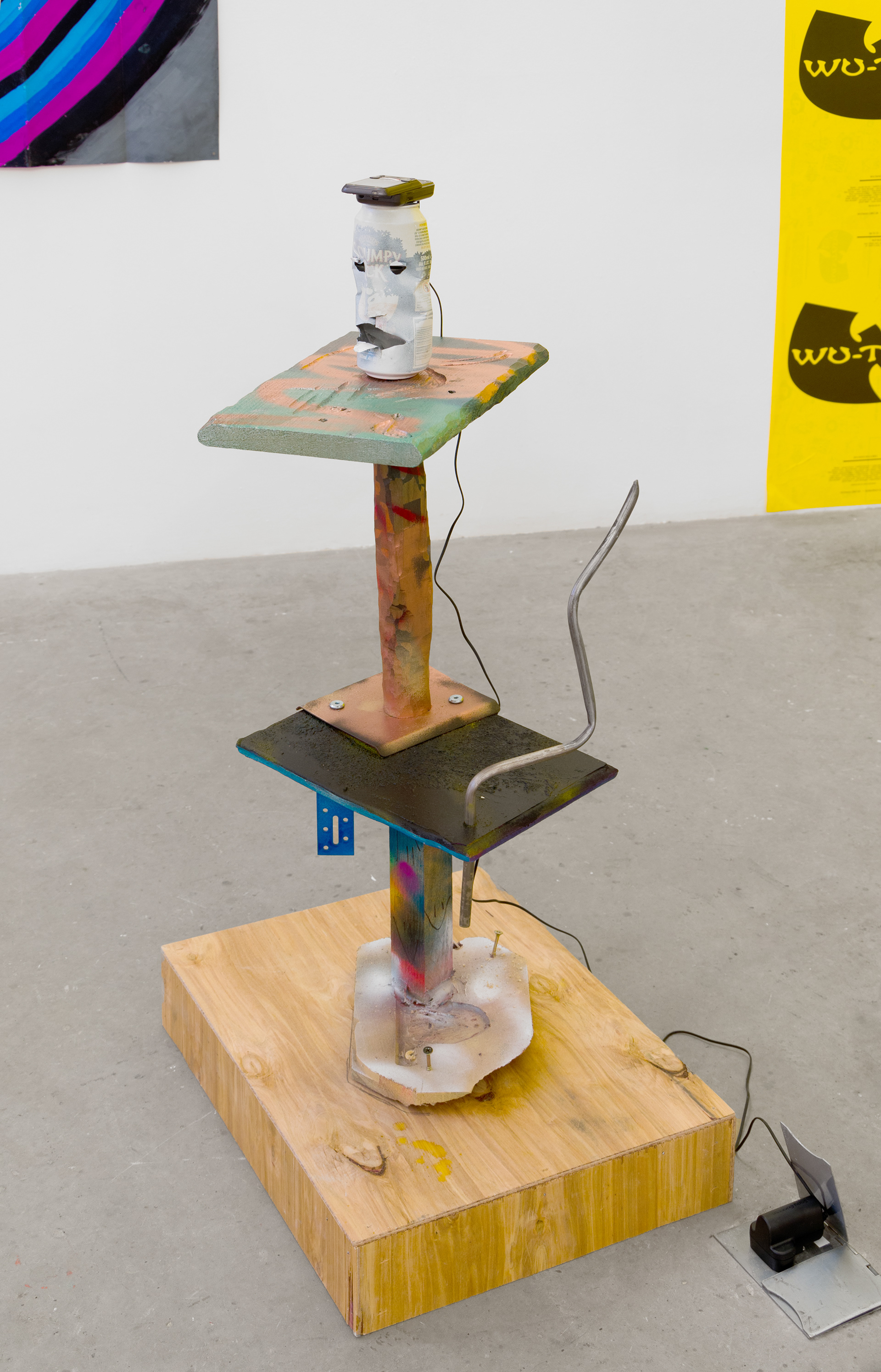 JUICY MOUTH (tonyhawksproskater1edit); 2013; Various hardwoods, spray paint, textured paint, marker pen, aluminium can, L-bracket, clamp, steel, plywood, mobile phone, mains charger, mp3 file; 95 × 52 × 39cm / 04:39:49