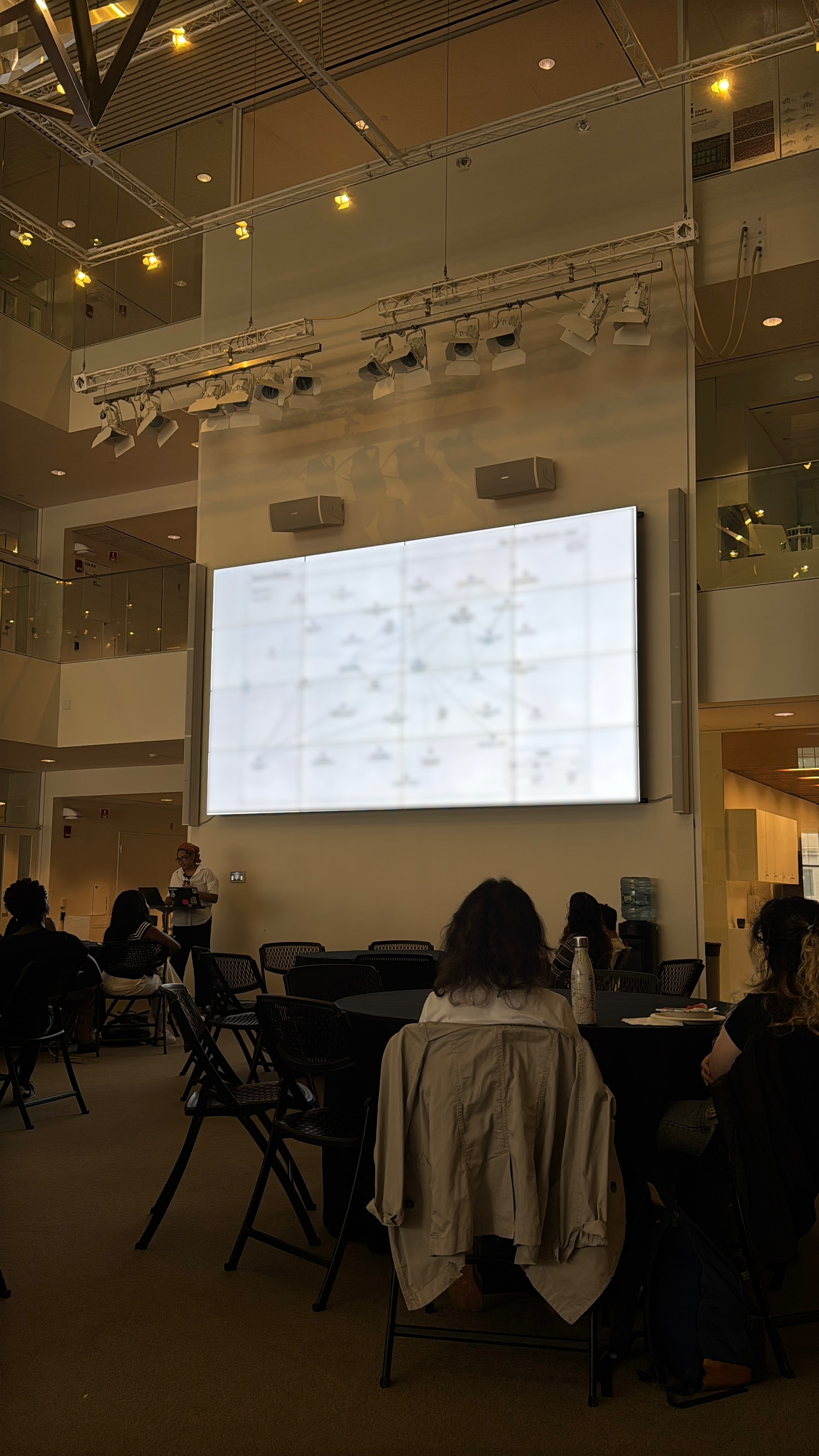 [Photo of me presenting my research in the atrium at MIT Media Lab]