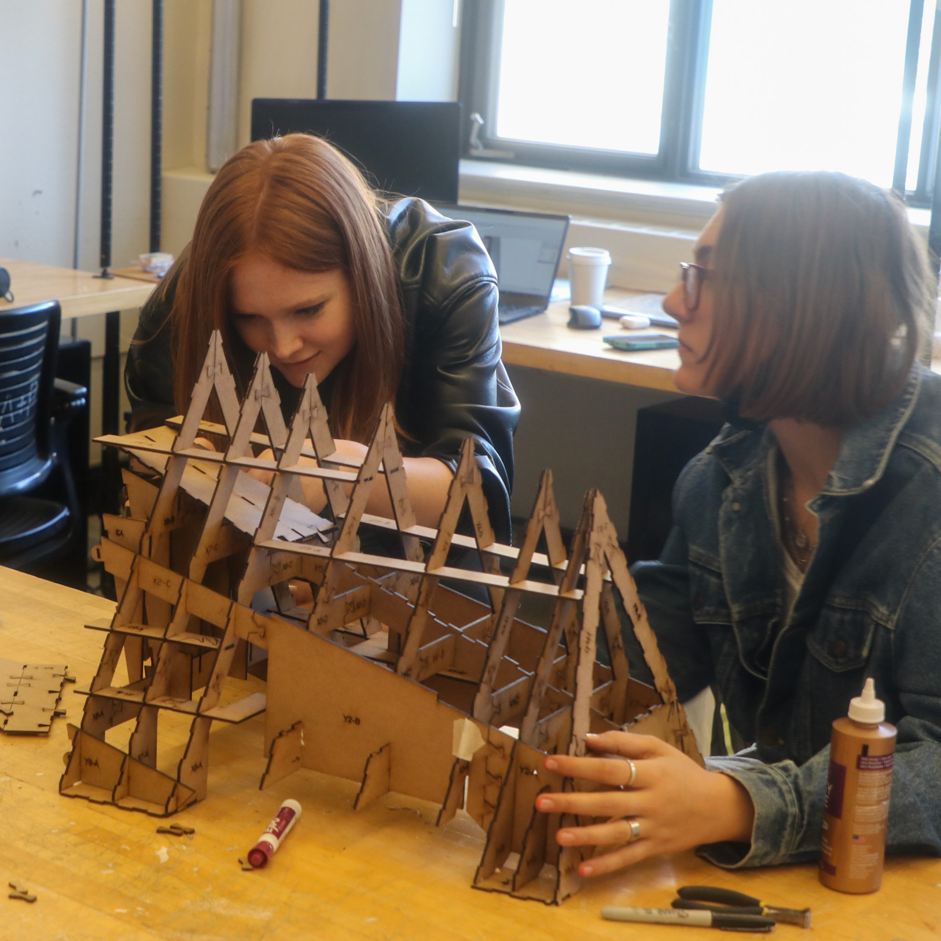 Nina Huttemann + Isabel Waitz assembling laser-cut 1/6 scale model