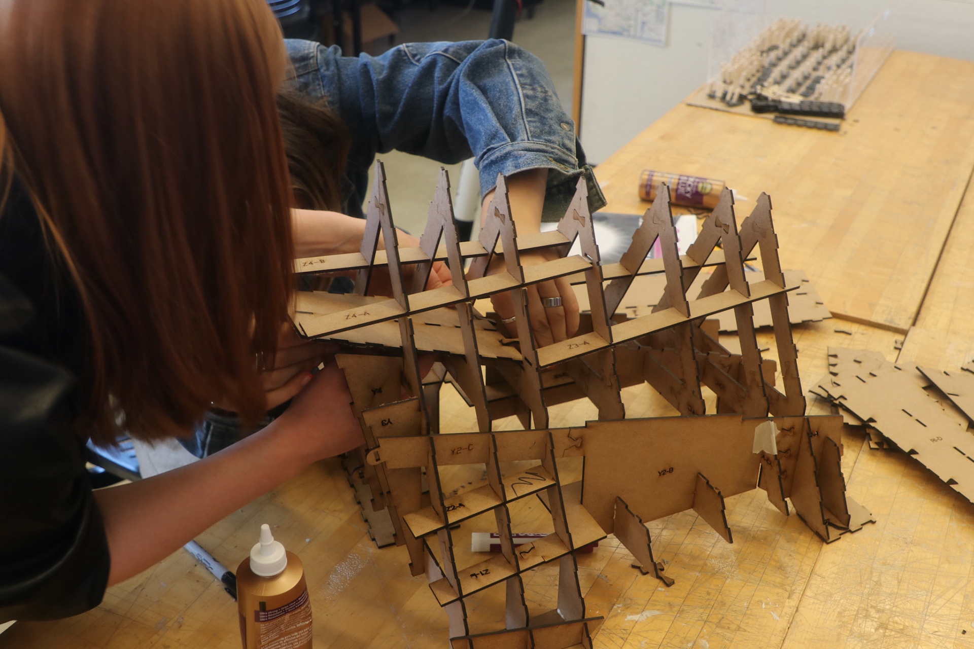 Nina Huttemann + Isabel Waitz assembling laser-cut 1/6 scale model