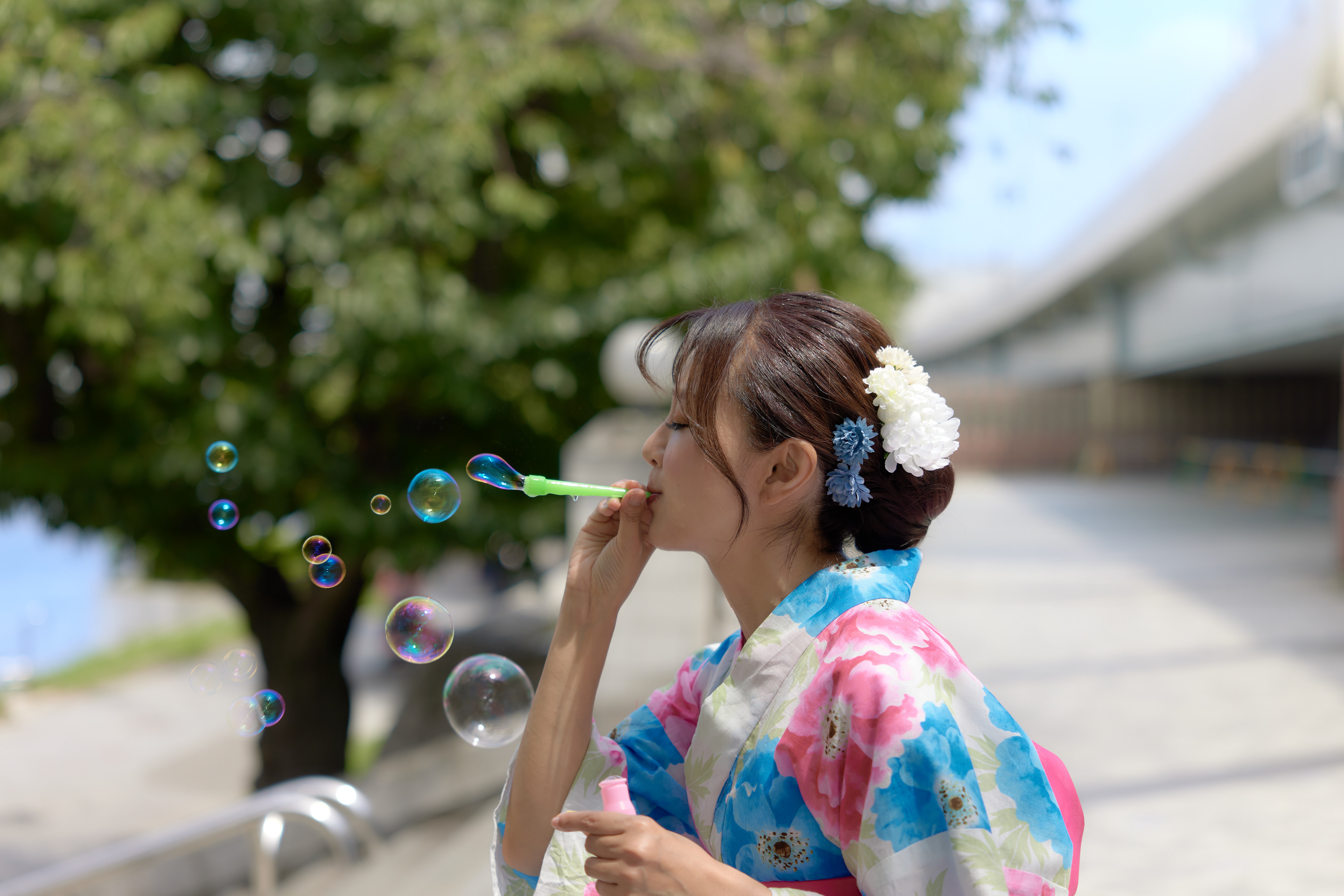 (工夫)日中シンクロ、露出調整、レタッチ、NDフィルタ、日中シンクロとNDフィルタで撮影、背景の木々や高速道路をぼかし、モデルとシャボン玉をきれいに再現しました／(カメラ)CANON EOS R5／(レンズ)CANON RF24-70mm F2.8 L IS USM／(撮影日)2022年8月20日／(撮影場所)隅田川 桜橋／(モデル)三宝愛久奈