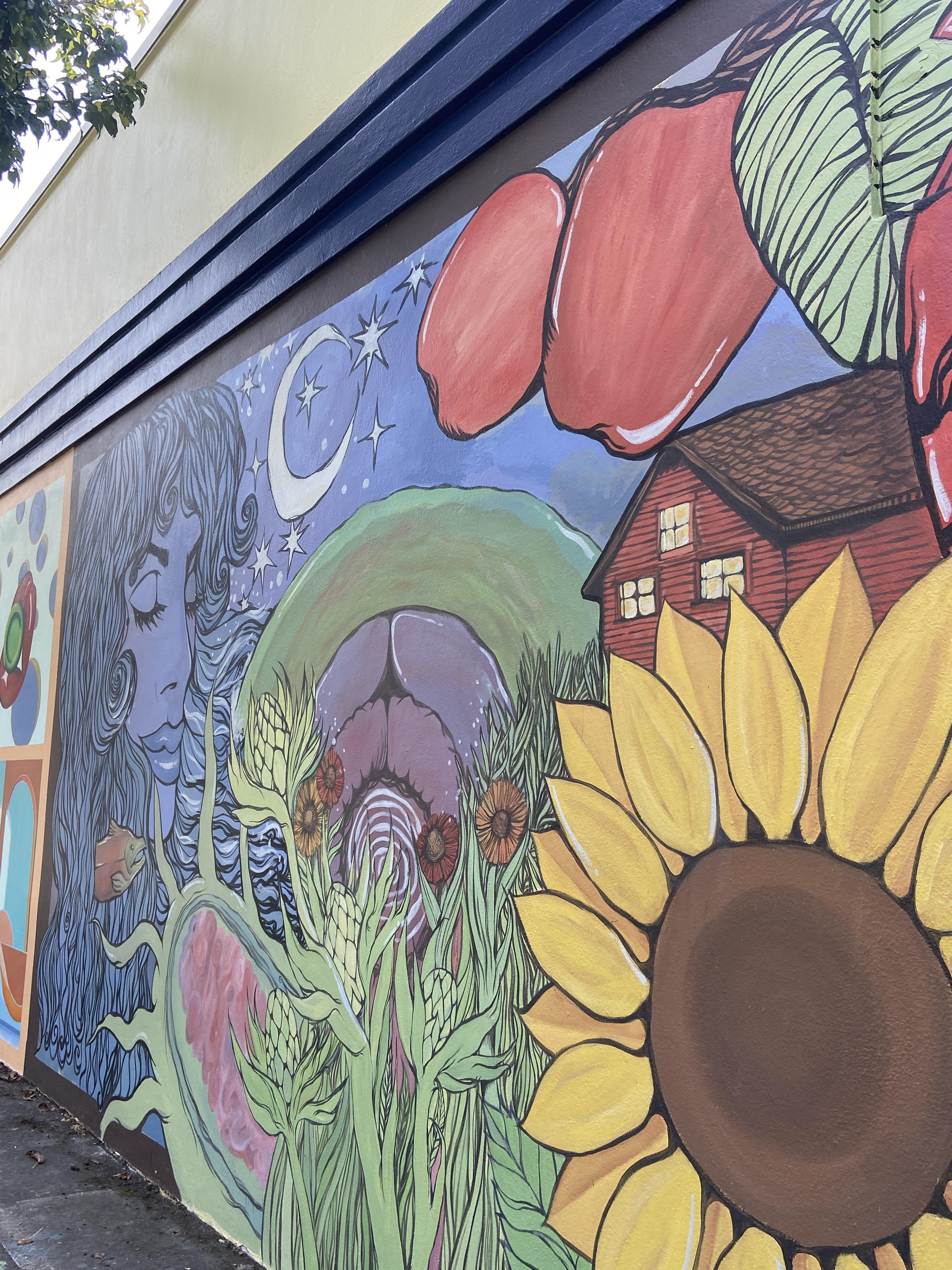Objects in order (left to right): Femme water figure, salmon, crescent moon, ocean waves, prokaryotic cell, artichoke/hop flowers, red flowers, eukaryotic cell, rosemary, apples, leaves, cabin, sunflower, human heart, swallowtail butterfly, and a tree.
