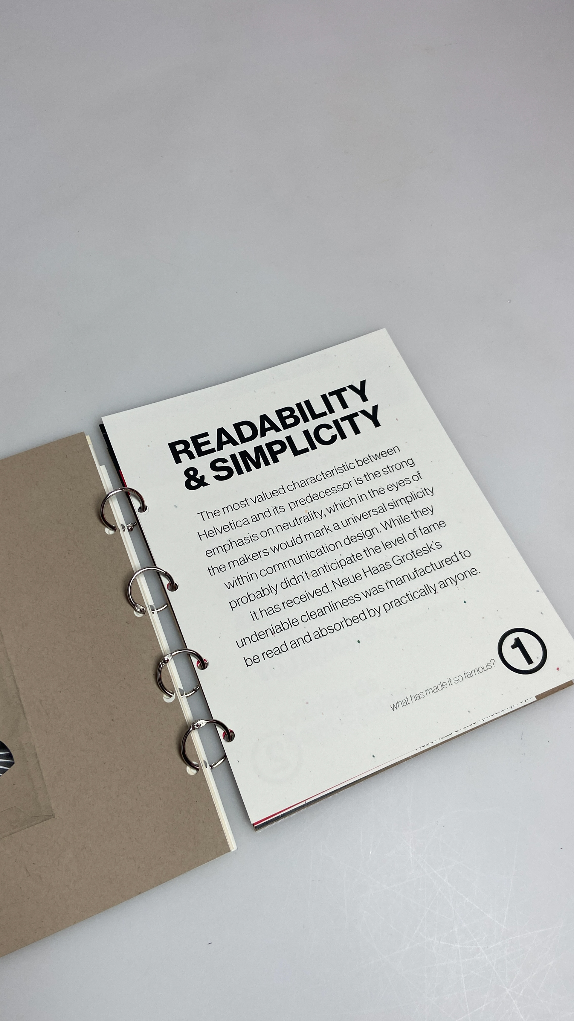 "Why is this typeface so famous?" On speckled white cardstock.
