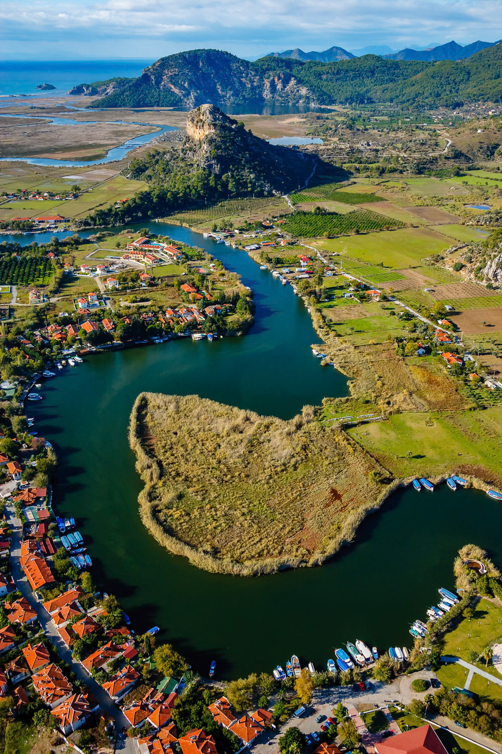 "Curves of Dalyan" - The small town of Dalyan is a settlement next to the winding river carrying the fresh water of the Koycegiz Lake to the Mediterranean Sea. The ruins of the ancient Carian trading city of Kaunos are behind the steep hill up ahead.
