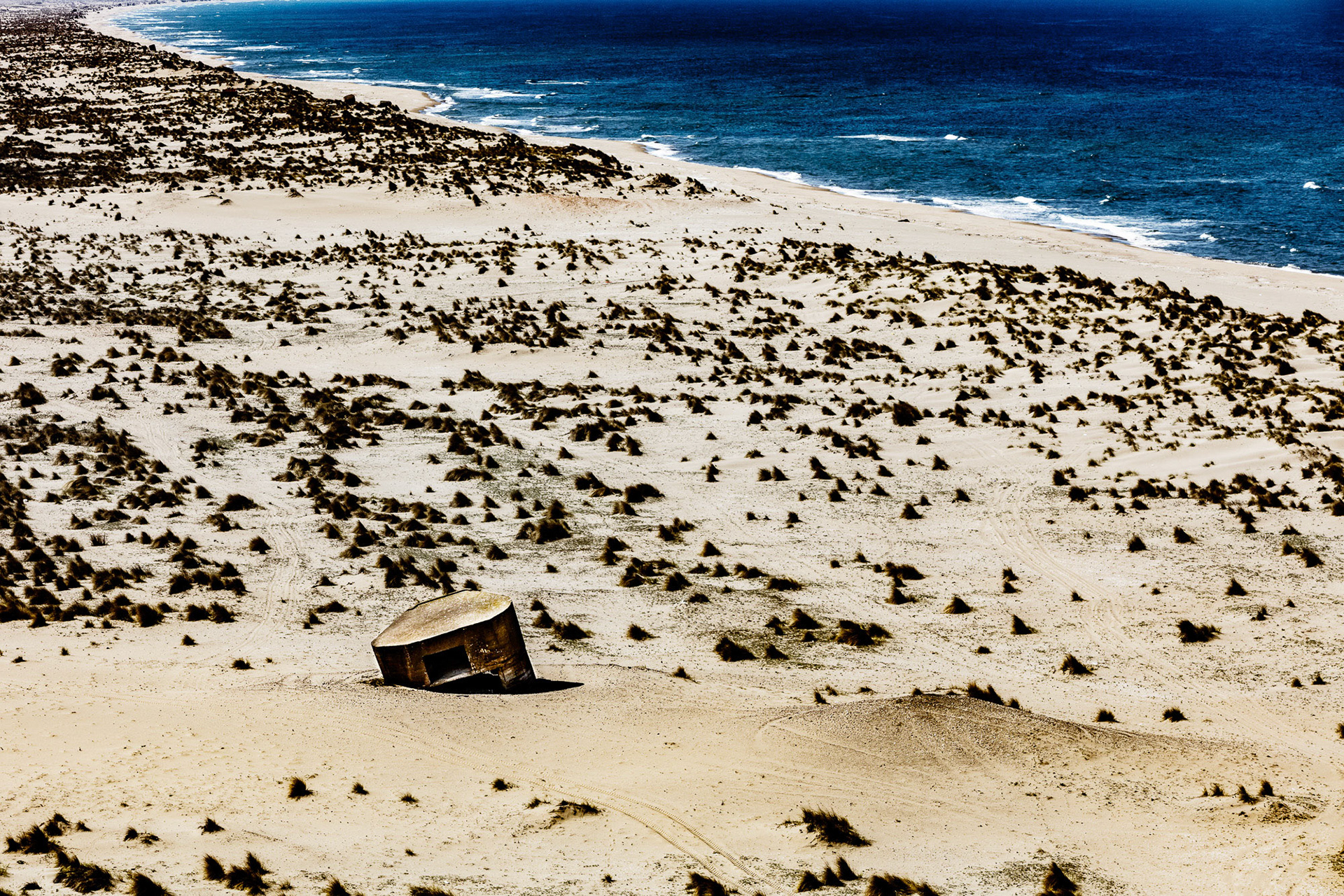 "Mirage" - The deserted WWII concrete bunker sunken and atilt on the sand tells me that nature always wins in the end.