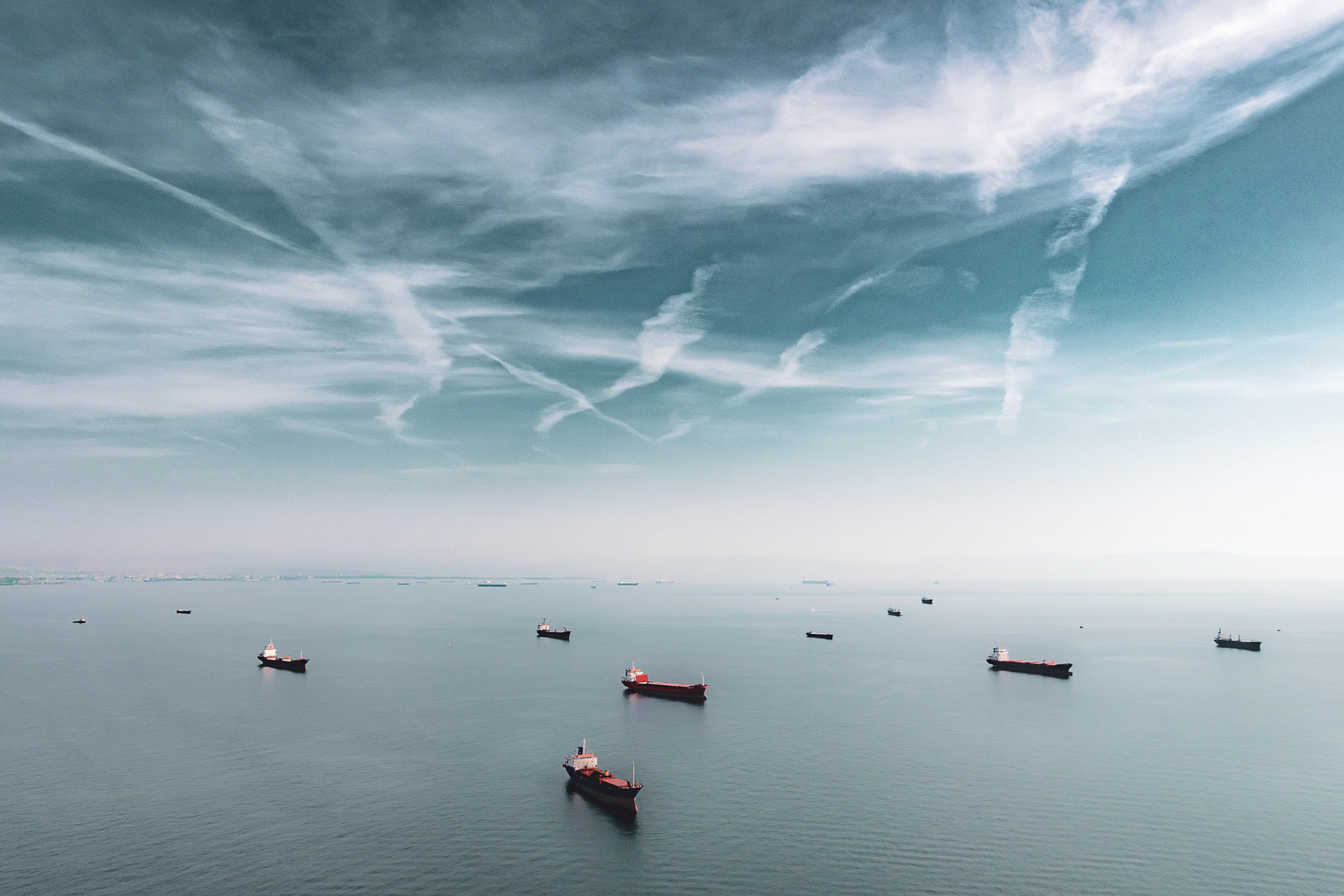 "In the Moment" - Being in constant motion in the air creates opportunities for interesting photographic moments. While flying in my paramotor along the Marmara Sea coast of Istanbul, once I realized the potential of the unusual clouds and the ships waiting in the calm sea, I positioned myself correctly and pressed the shutter button.