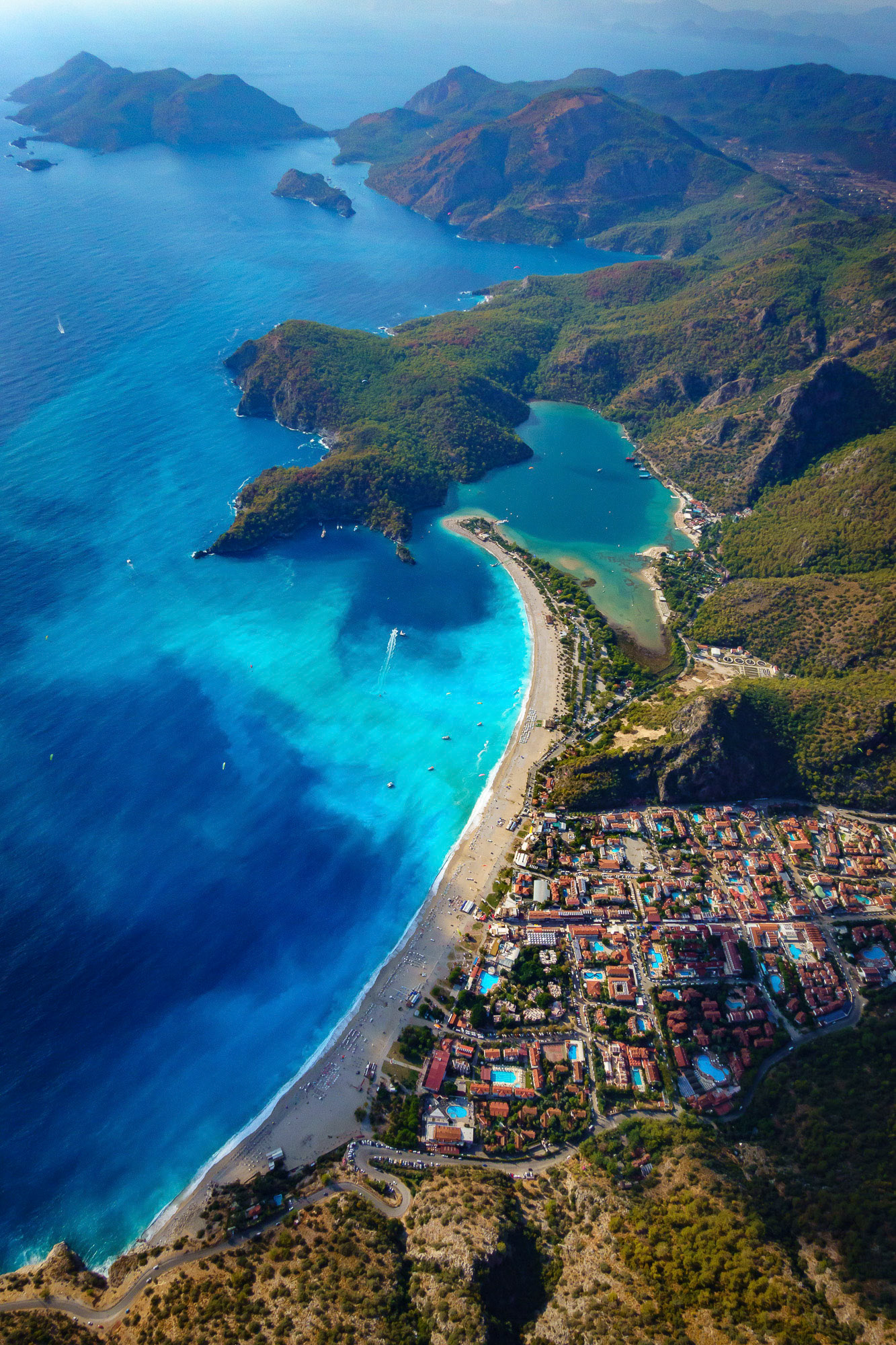 "Oludeniz Blues" - Oludeniz, a paragaliding paradise, from the air after a storm in the autumn sun. I shot the long beach, many shades of the blue Mediterranean water, the lagoon and the Gemiler Island as I glided down from the top of the mountain.