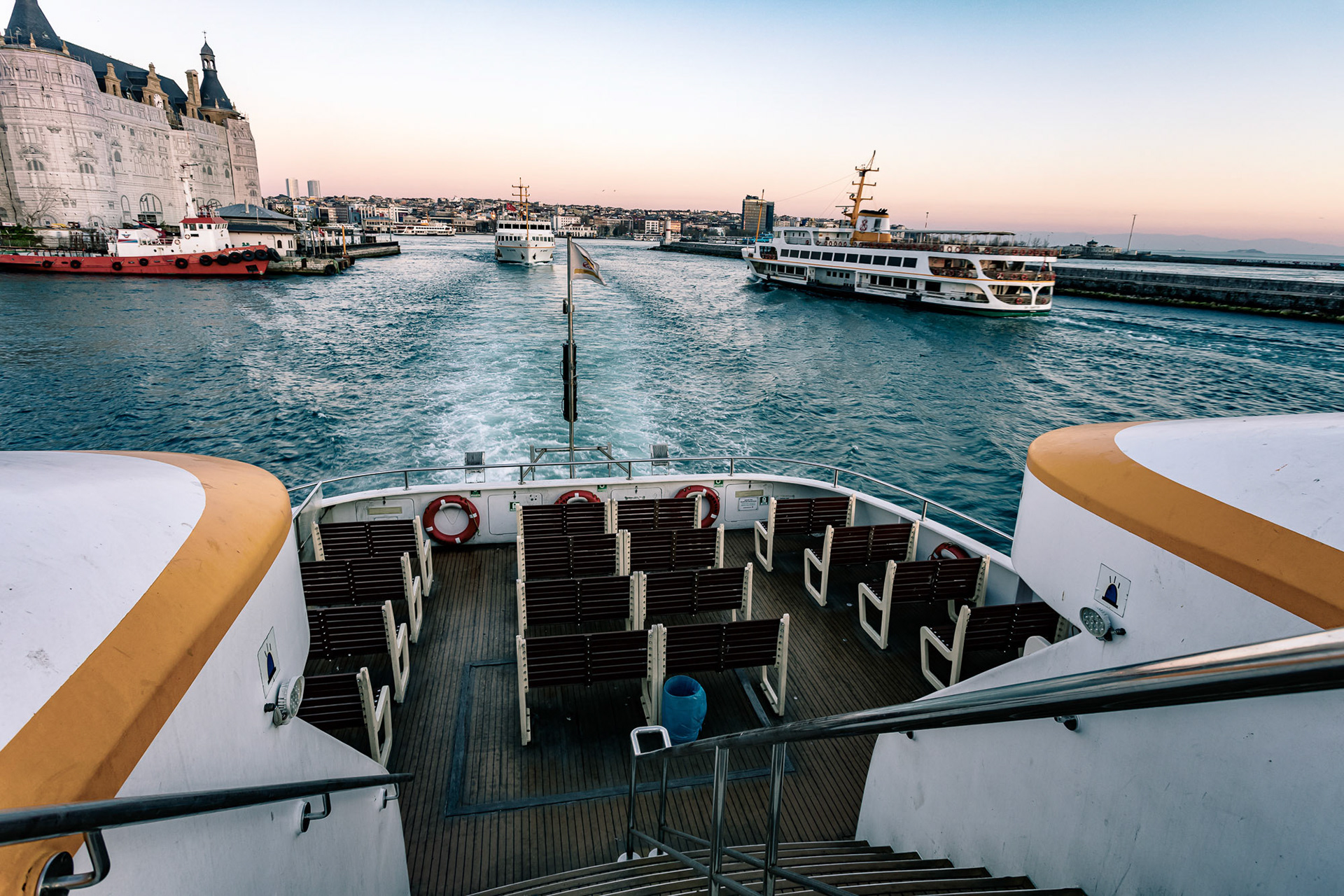 "Empty Seats" - The new type ferry carries nobody on the outer seats and just a few inside as it passes by the Haydarpasa train station alongside nearly empty classical ferries.