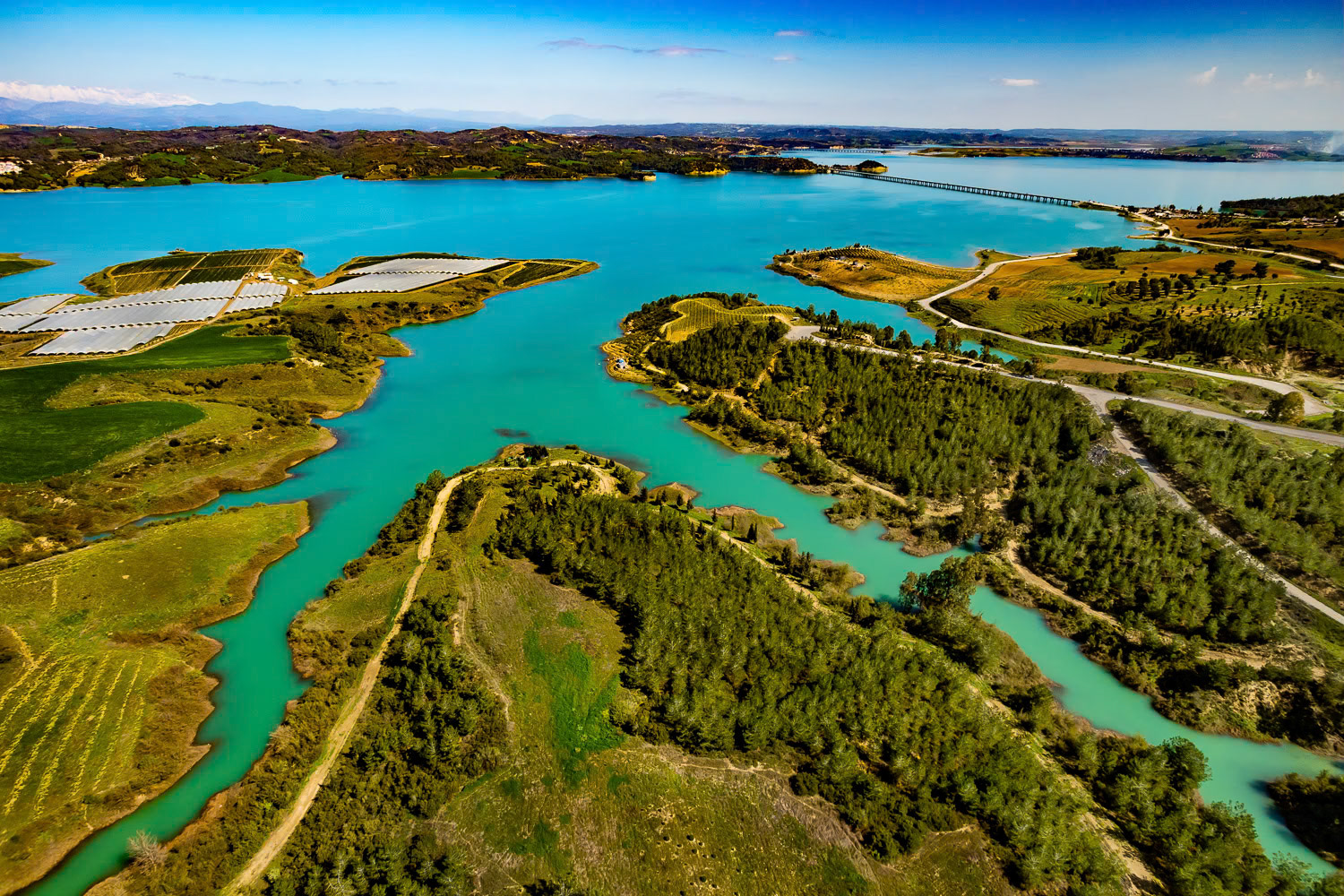 "Dam Lake" - Built in 1953, Adana Seyhan Dam is still used for hydroelectricity generation and modern irrigation of the entire Çukurova region. I wanted to shoot the Dam Lake, an artificial lake, with its fjords. Although we found the takeoff point I had discovered 12 years ago to fly in the same region, there was a very narrow area left because the water level rose. Since we couldn't find a more suitable area considering the wind direction, I took the risk of the wing falling into the water. Fortunately, I successfully took off, flew and landed.
