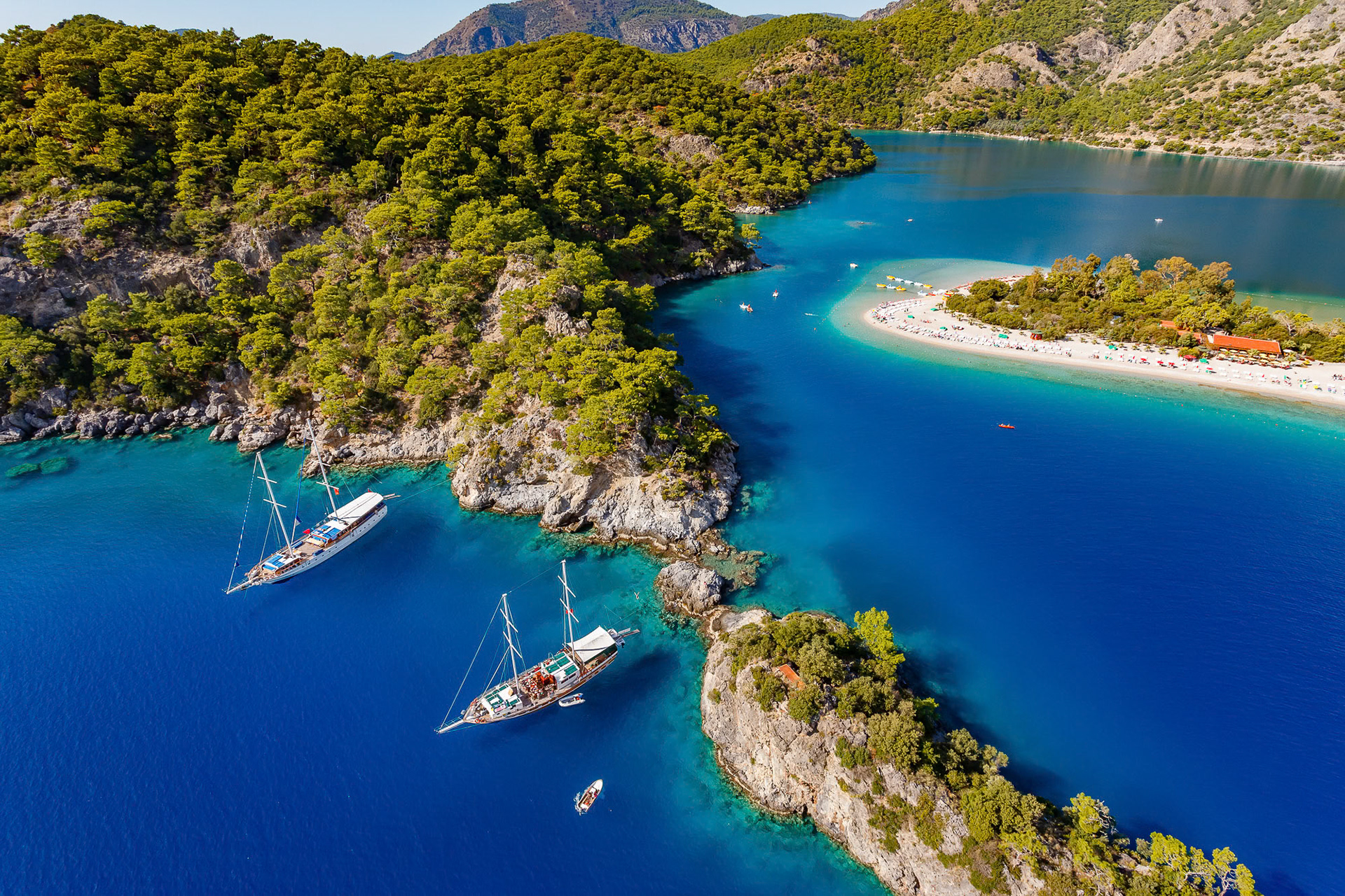 "Lagoon" - Oludeniz Lagoon is a piece of heaven and one of the most popular spots in the world for paragliding. To be honest it looks much nicer from the air. Shades of green, blue and sand colors come together in beautiful natural lines and curves. Two gulets anchored in the foreground are wooden liveaboard sailboats which are on a "Blue Voyage". Luckily not many paragliders could fly to this end of the beach this low, so I could take my time shooting.
