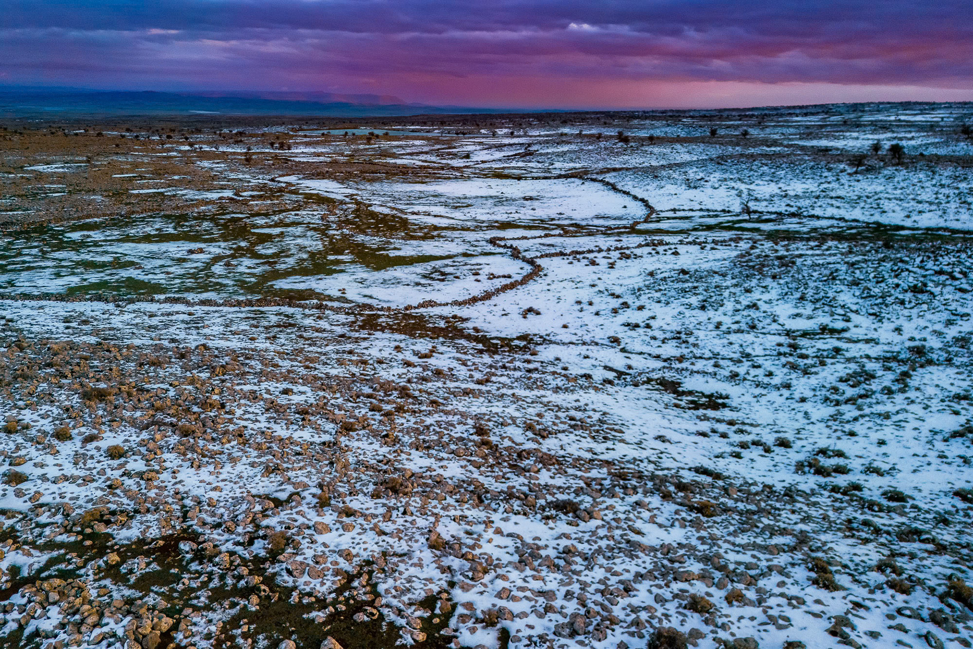“Field of Rocks” - Aerial dusk photograph in southeastern Turkey near the Syrian border. The whole area is covered with volcanic rock spewed by an ancient volcano making farming very difficult. The thin snow cover reveals the nature of this demanding land.