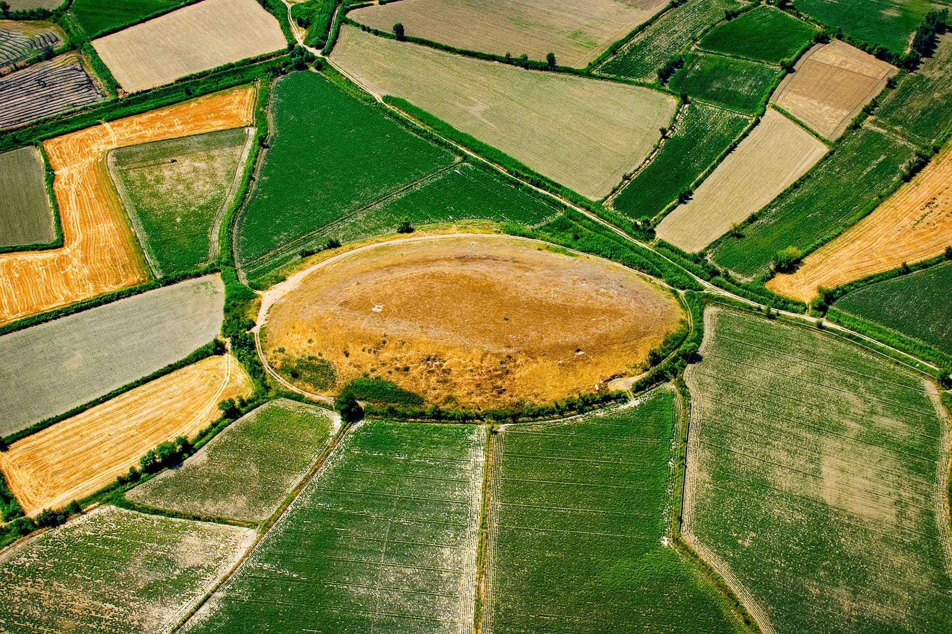 "Saraykoy Mound (II)" - The mound in the Saraykoy Mound (I) photo as seen from the air. How things change when one changes the angle of view! Due to the very turbulent inland winds during the hot summer months I was able to fly with my paramotor just once on the expedition for the series and captured this graphic image. I ended up staying too long in the air, ran out of gas, landed in a corn field and hitched a ride on a tractor, but it was worth it!