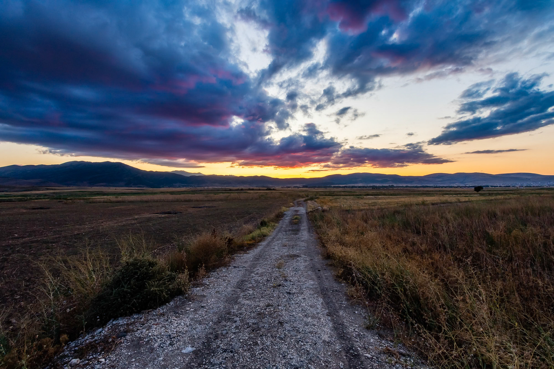 "Anatolian Landscape" - This image which I took on the way to the south represents Anatolia for me. The village road, the grassland, the crop field, the volatile sky, the mountains in the distance and the colors all came together to give me that vibe.