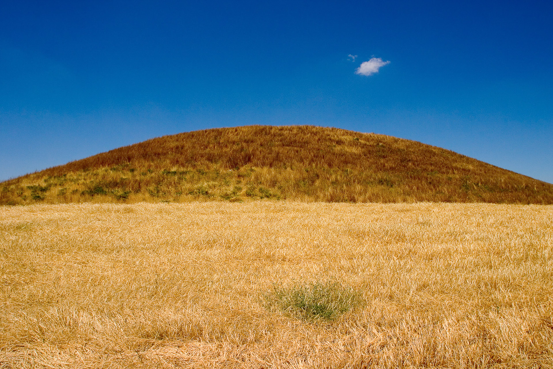 "Saribeyli" - A perfect typical mound separating the sky and the field right in the middle. I love the tiny white cloud reflecting the green weed on the ground.
