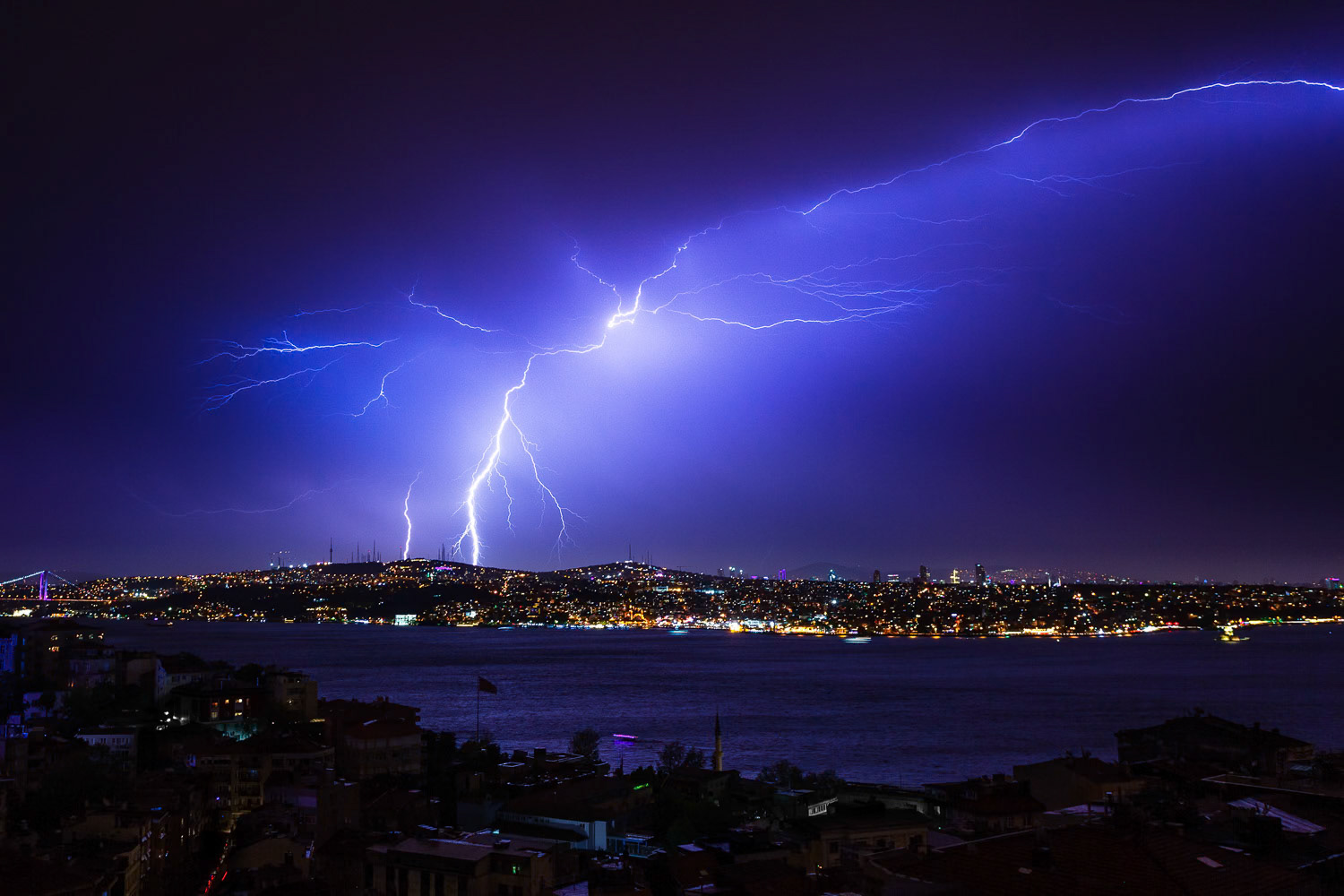 "Lightning Strike over Bosphorus" - I love capturing hard to catch phenomena on camera. On one May evening a storm was producing lightning strikes one after another. I set up my camera overlooking the Bosphorus and waited for the perfect one which came eventually. This type of photography requires all skills including patience.