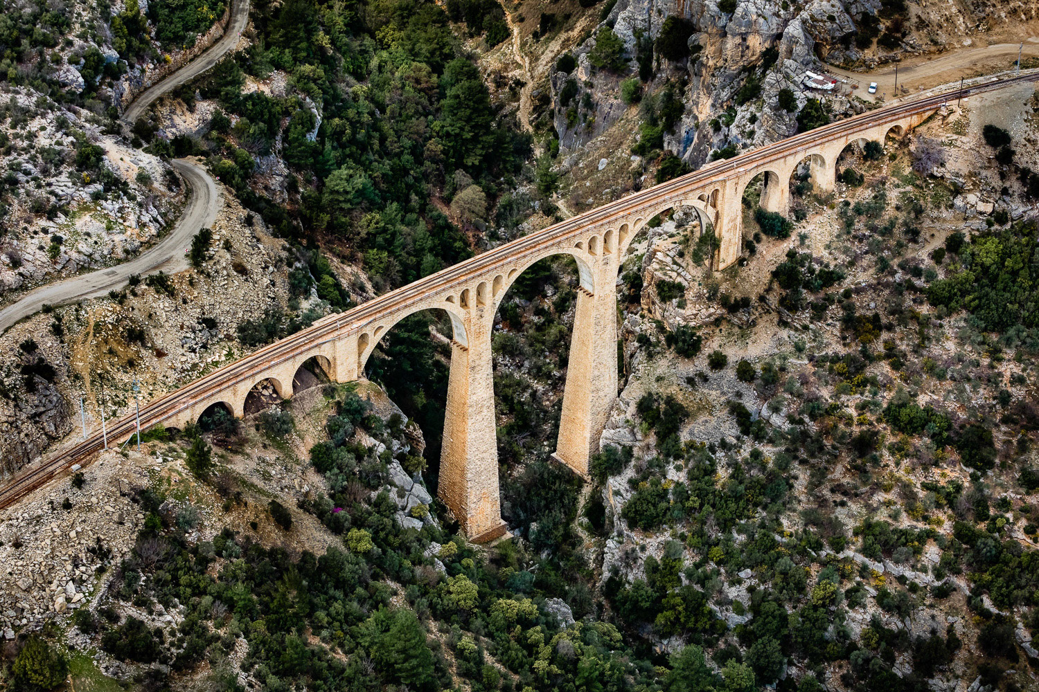 "Varda Bridge" - Varda Bridge is a 172 meter long stone masonry-type bridge, built with great difficulty at the beginning of the 20th century by German engineers and still in use today. The bridge is in a risky place for flying. After a long, winding journey, we arrived at the bridge in a valley of the Taurus Mountains. We searched for a flat and open area for my takeoff. Fortunately, we found a field not too far from the bridge. I shot the bridge in a turbulent air with downdrafts that threw me around, due to the shape of the land. Not a comfortable flight at all! Nevertheless, it was a great pleasure to photograph this historical monument.