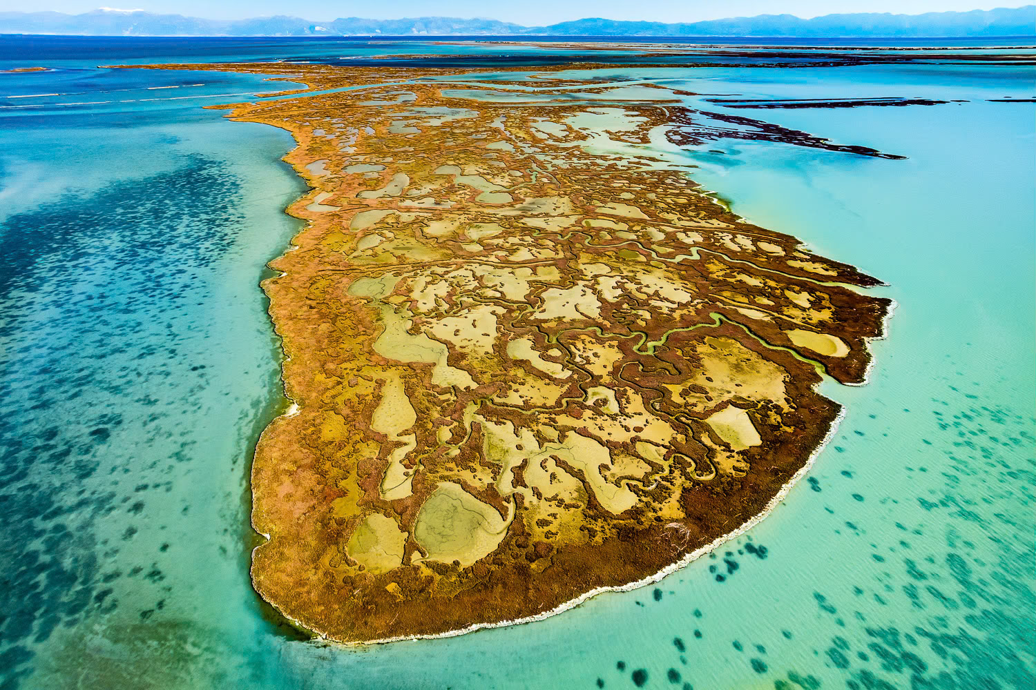 "Yumurtalik 2" - There is a giant wetland system between the mouth of the Ceyhan River and the Yumurtalik Gulf, consisting of lagoons, salt marshes, mud flats, reeds, wet meadows, sand dunes and a pine forest. The main wetlands are the Yumurtalik (or Çamlik) lagoon and the fisheries inside of these. The salt marshes in Yumurtalık, which take on different colors in different seasons, looked like a thin line when viewed from land. When I went up in the air I met with a scene evocative of tropical paradise islands.