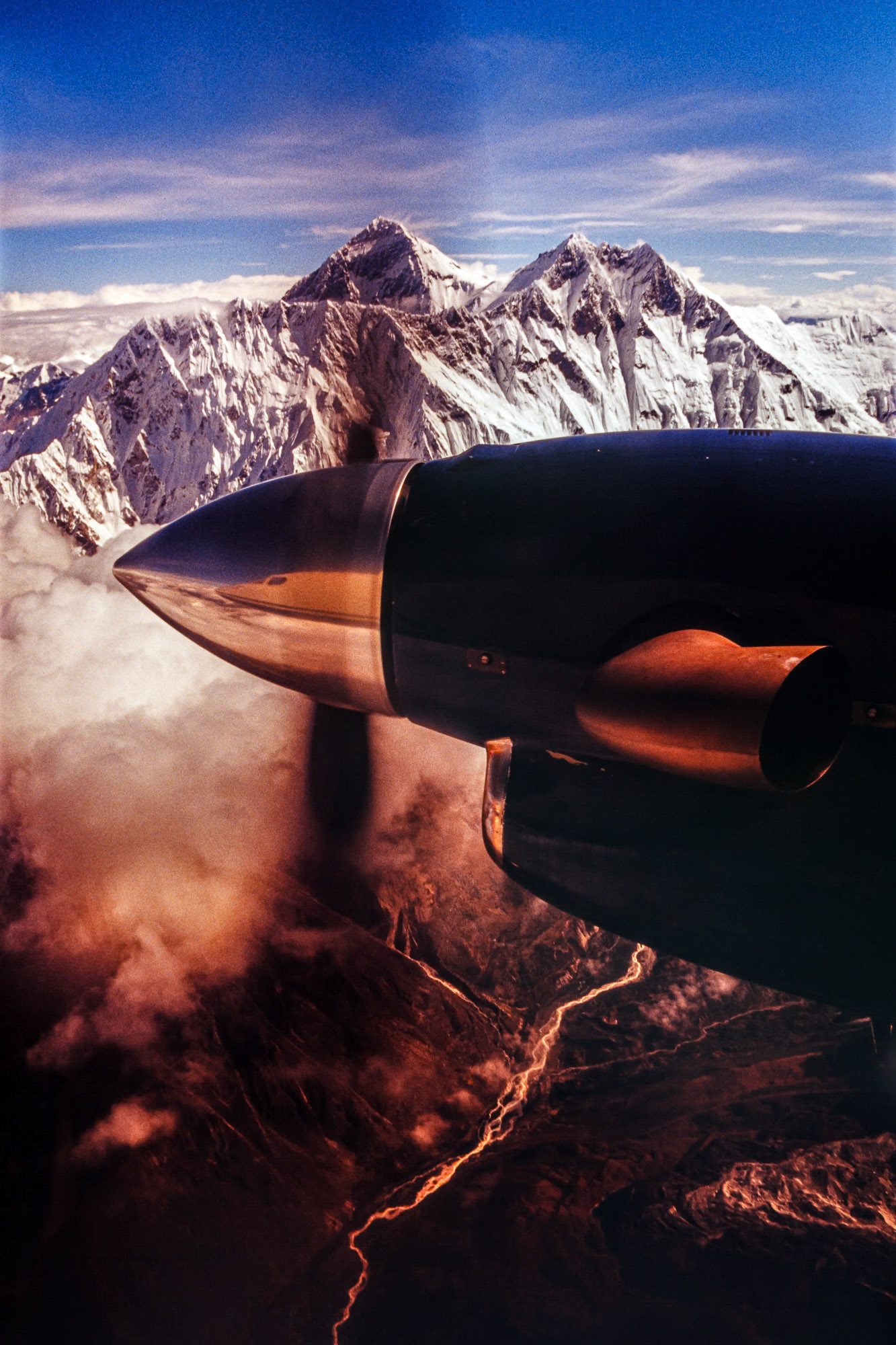"Everest" - During one of my travels to Nepal and India, I took a twin engine airplane from Kathmandu to see the Himalayas from the air. This image of Mt. Everest with the engine and propeller is one of my most popular images, and I shot it on film. I had to carry with me many rolls of transparency film and tell whatever necessary to the security people at airports to prevent the films from going through primitive x-ray machines multiple times. Am I glad those days are over!
