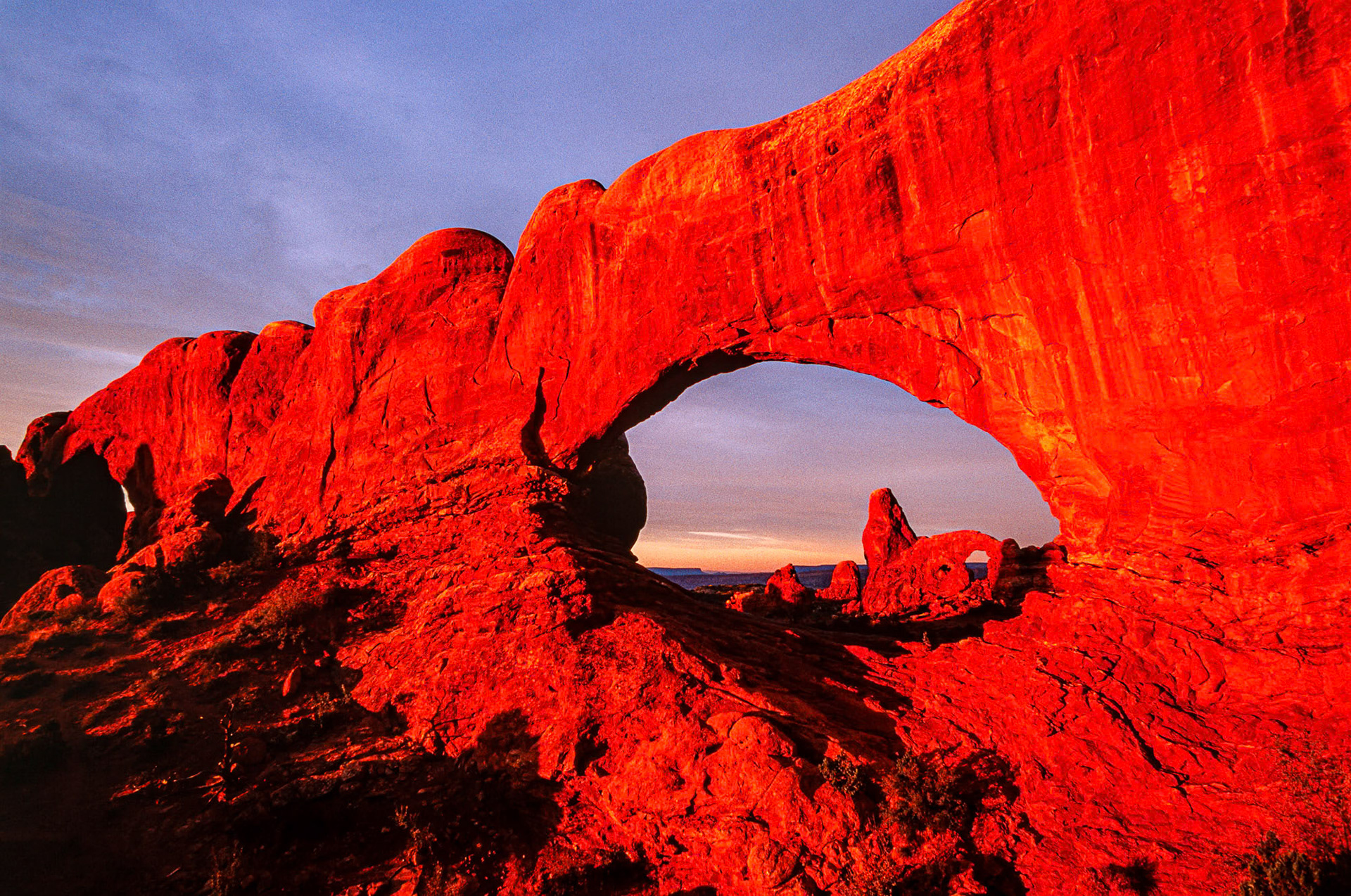 "North and South Windows" at the Arches National Park in Utah, USA. Those rocks glow, I mean really glow at sunrise. When one is serious about photography one learns early on the importance of sunrises and sunsets. You get up while it is still dark, find your spot, set up your camera and wait. Breakfast comes later.