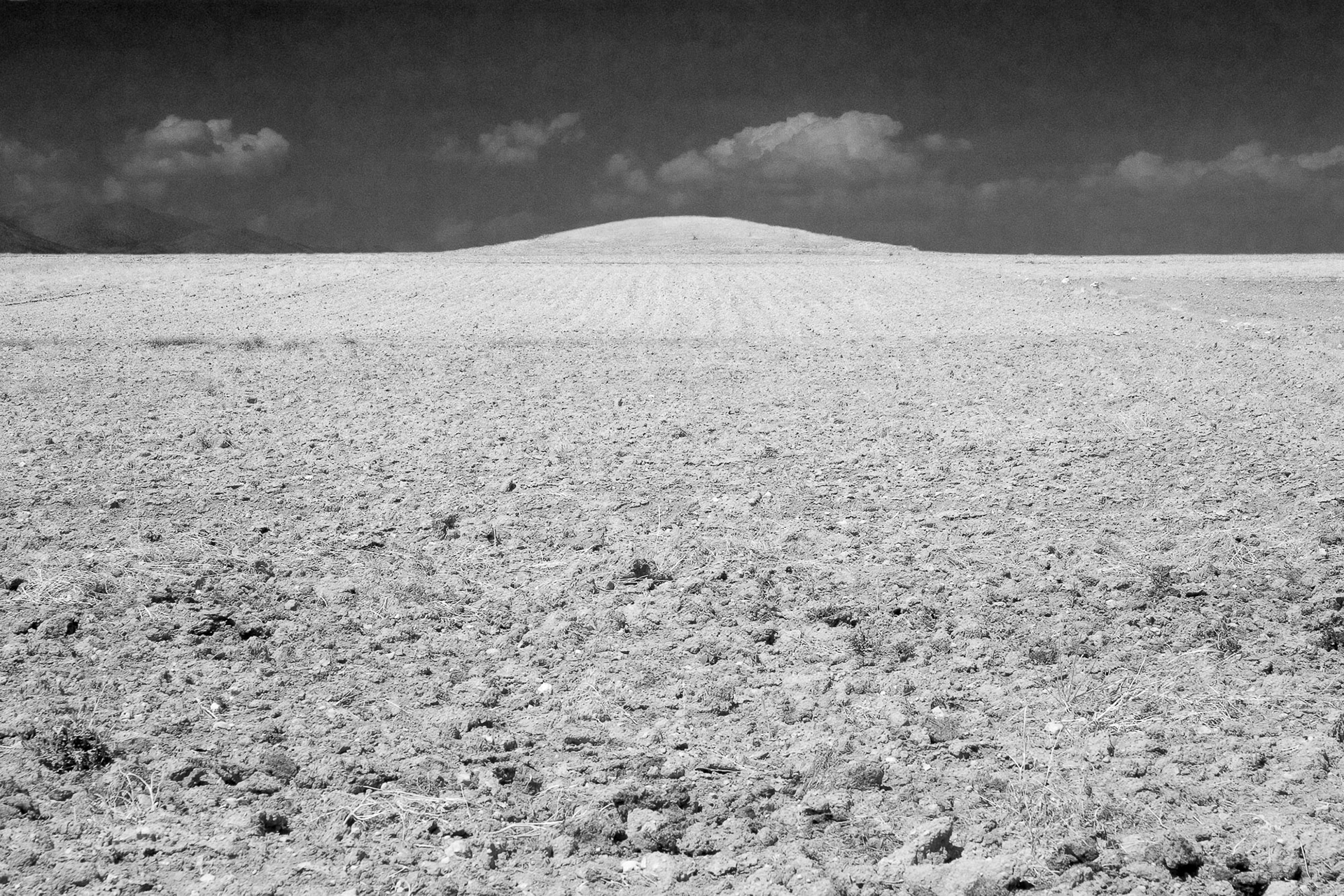 "Kucukhoyuk" - I shot this lonely mound from a distance showing the plowed crop fields surrounding it as if they are about to devour it.