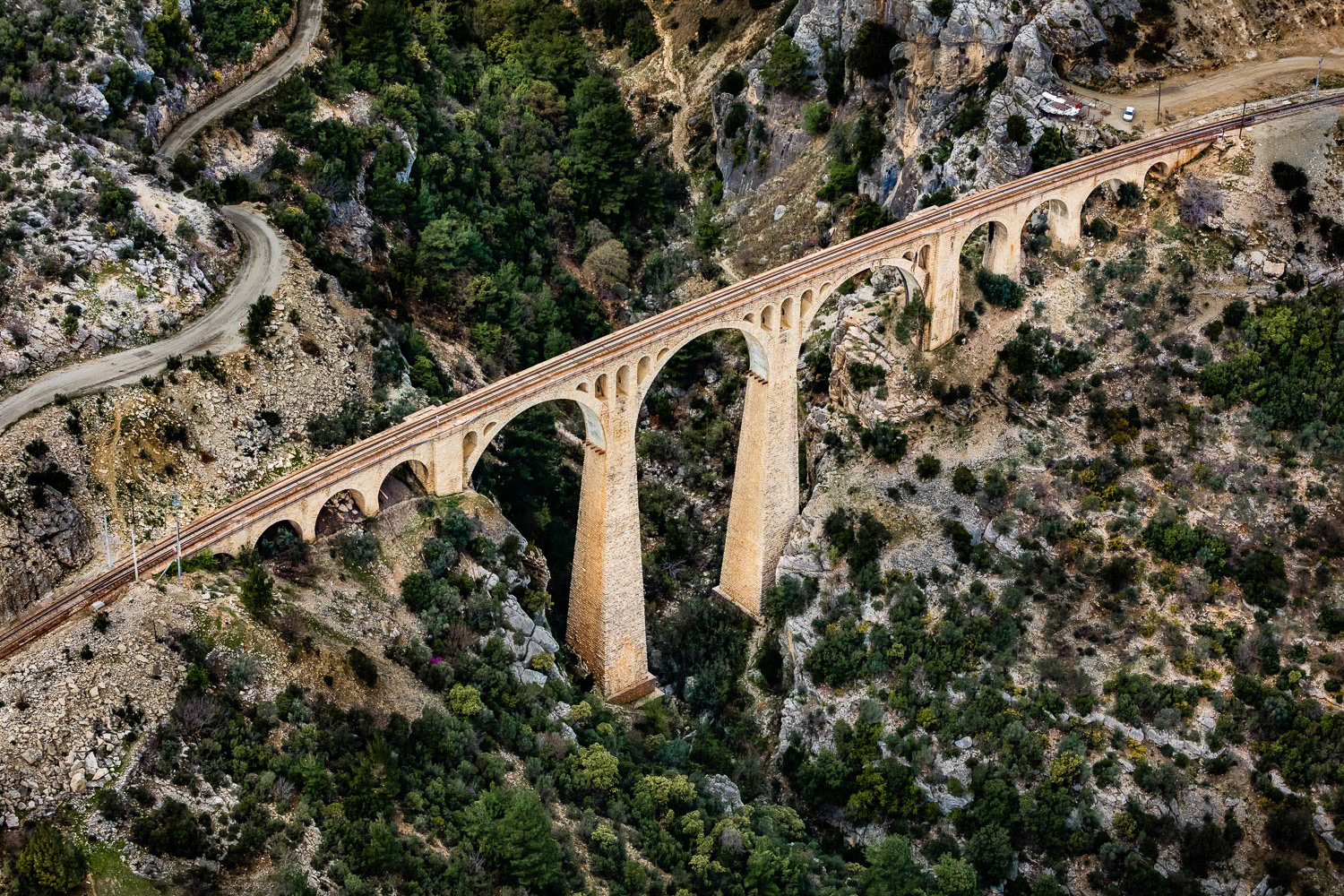 "Varda Bridge" - Varda Bridge is a 172 meter long stone masonry-type bridge, built with great difficulty at the beginning of the 20th century by German engineers and still in use today. We knew that this aesthetic bridge was located in a risky terrain for flying. After a long and winding journey, we arrived at the bridge in a valley of the Taurus Mountains. We searched for a flat and open area for my takeoff. Fortunately, we found a suitable field not too far from the bridge. I photographed the bridge in a turbulent air with downdrafts that tossed me around due to the shape of the land. Although it was not a comfortable flight, it was a great pleasure to photograph this historical structure.