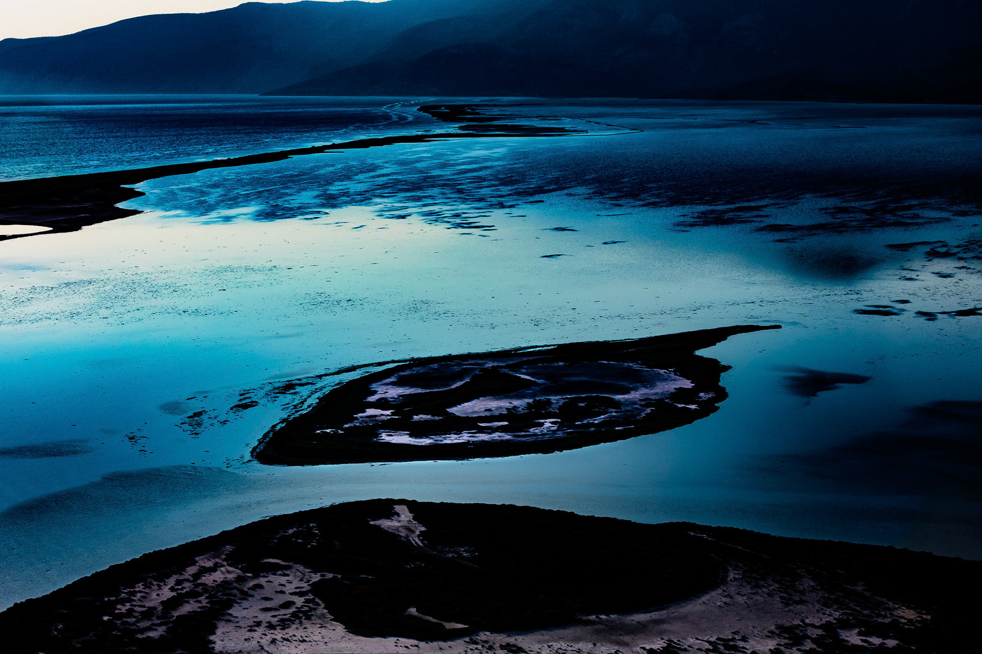 "Dark Island" - The interaction of different elements; tones of blue, light and dark, reflection, shapes and textures; tells me a mysterious and otherworldly story.