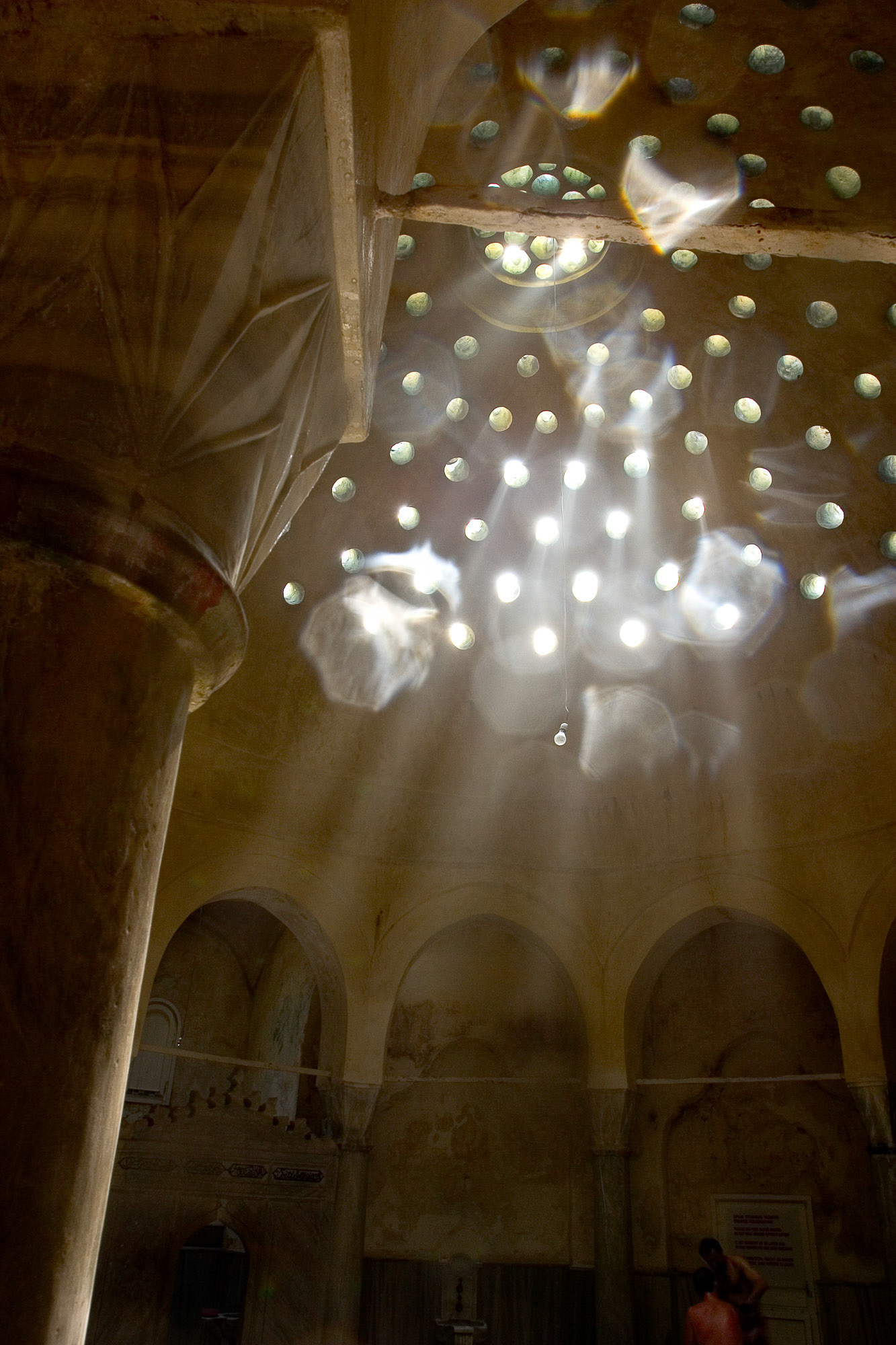 "Bath" - Light beaming through the dome of the ancient Cemberlitas Hamam gives a mystical quality to the steaming hot Turkish Bath. I had only a few minutes before my camera equipment started to melt!