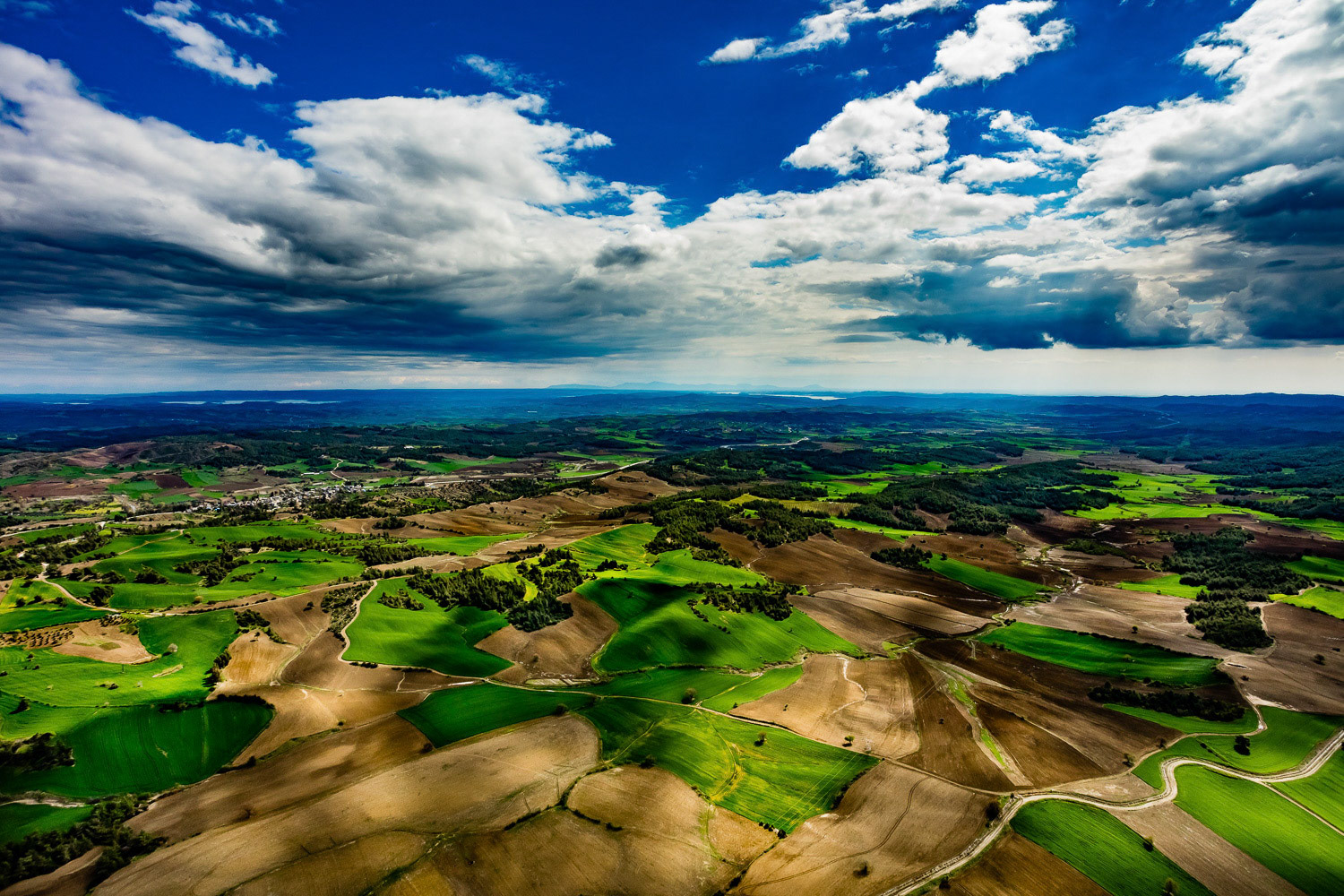 "Karaisali" - Karaisali is a town located 51 km north-northwest from the Adana city center and has been home to various civilizations since it was founded by the Romans. It always attracts tourists with its historical and natural parks. The stunning aesthetic created by the wild colors of the nature in spring preparation and the giant Cukurova's farmland and the seasonal clouds that I witnessed during this shoot have made me to feel like flying inside of a dramatic oil painting.