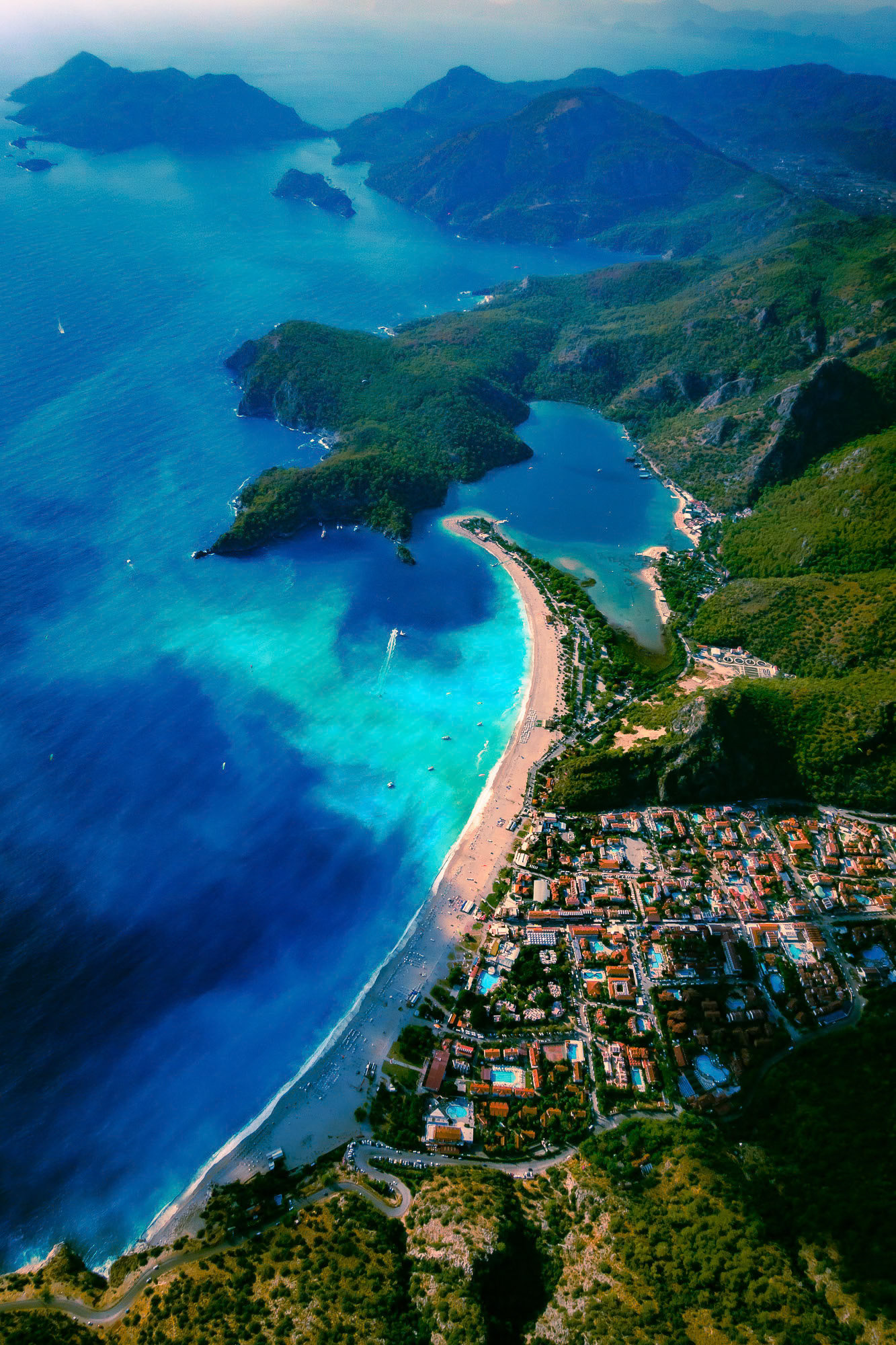 "Oludeniz Blues" - Oludeniz, a paragaliding paradise, from the air after a storm in the autumn sun. I shot the long beach, many shades of the blue Mediterranean water, the lagoon and the Gemiler Island as I glided down from the top of the mountain.