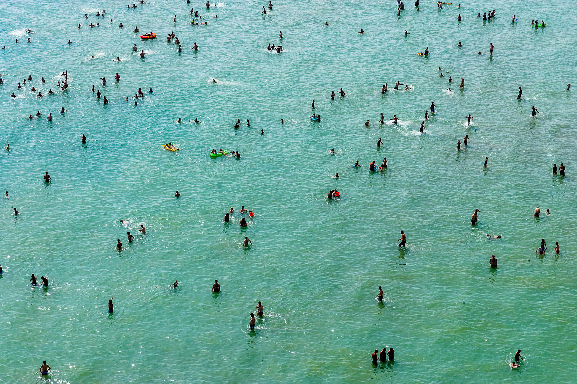 "Summer" - I was flying along the Marmara Sea in hot hot weather keeping my eyes open for interesting subjects. I saw this even distribution of people waist deep in the greenish blue water. They were oblivious to what was going on around and above them (me), but rather just cooling down and enjoying the summer. I had a winner minimalistic photo...