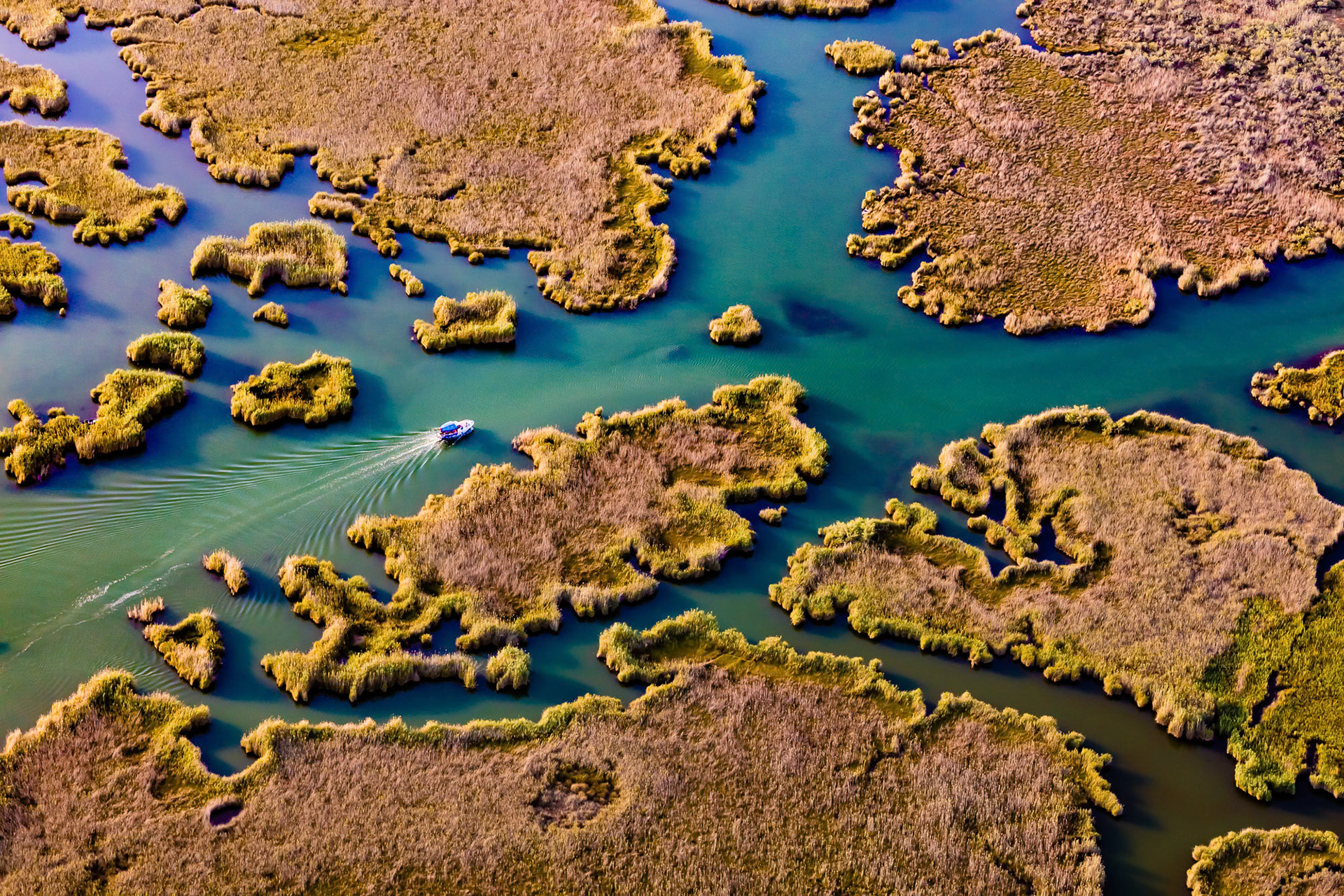 "Shades of Dalyan" - Dalyan is a magical wetland area with water plants, islets, canals and historical ruins. Flying over it is always delightful. Ever-changing colors give me unique photo opportunities. How do the boaters find their way in the natural maze of the Dalyan canals, I have always wondered. I suppose it is ingrained in them throughout generations.