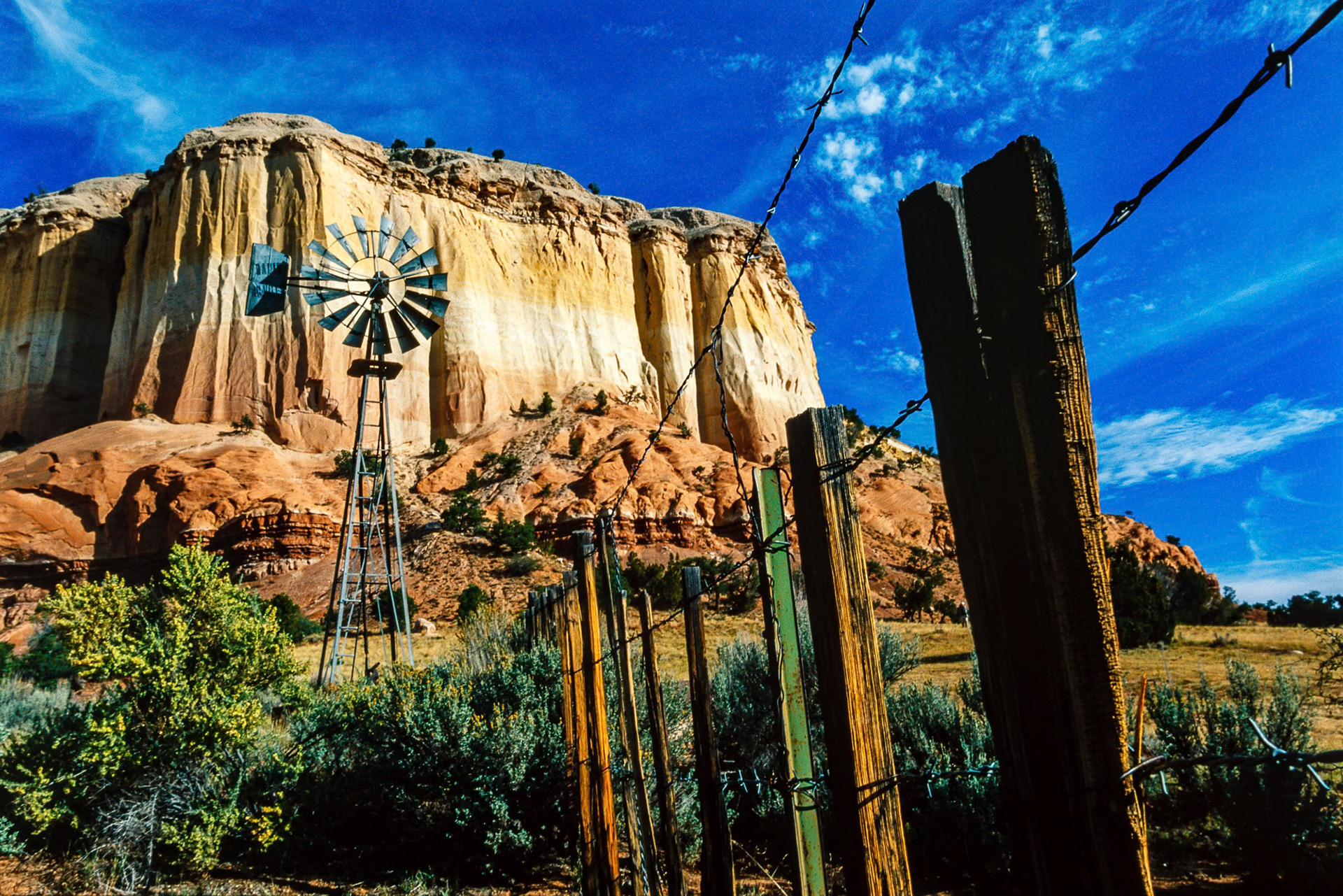 "Vista" - I have shot this windmill, fence and layered rocks composition at an unusual angle in New Mexico, USA. It works!