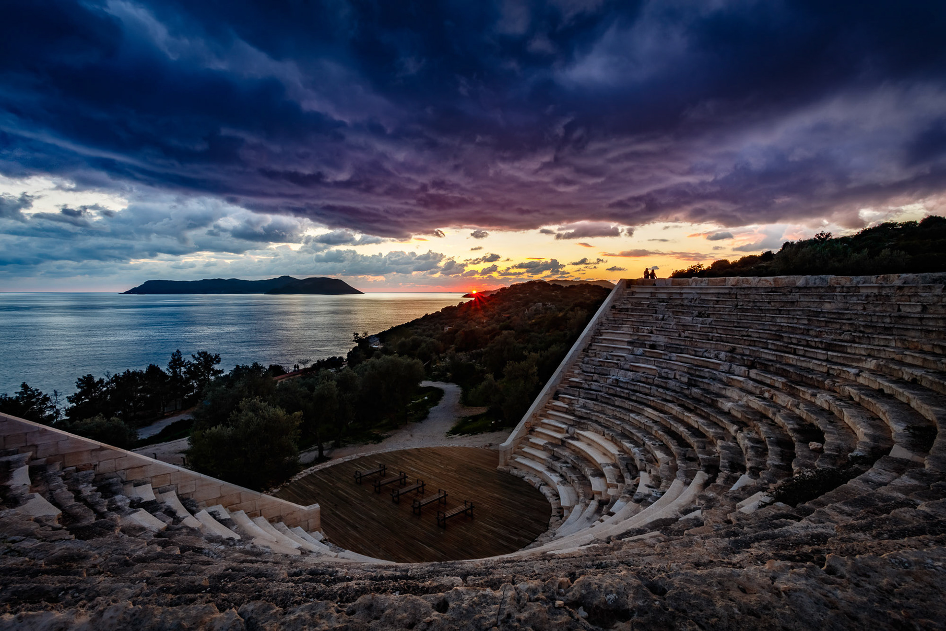 "Kas" - I decided to begin the new year in the beautiful Mediterranean town of Kaş, Turkey. I go to Kaş every summer for flying, diving and fun but it's my first time there in winter. It's much calmer and the weather is less predictable. When I saw the potential of a dramatic shot late afternoon I quickly headed for the ancient Hellenistic theater crosstown and got this image. The island in the image is Kastellorizo. I found the best view by lying on the time worn stones of the theater. I am very happy with the way the composition, the colors and the elements all came together.