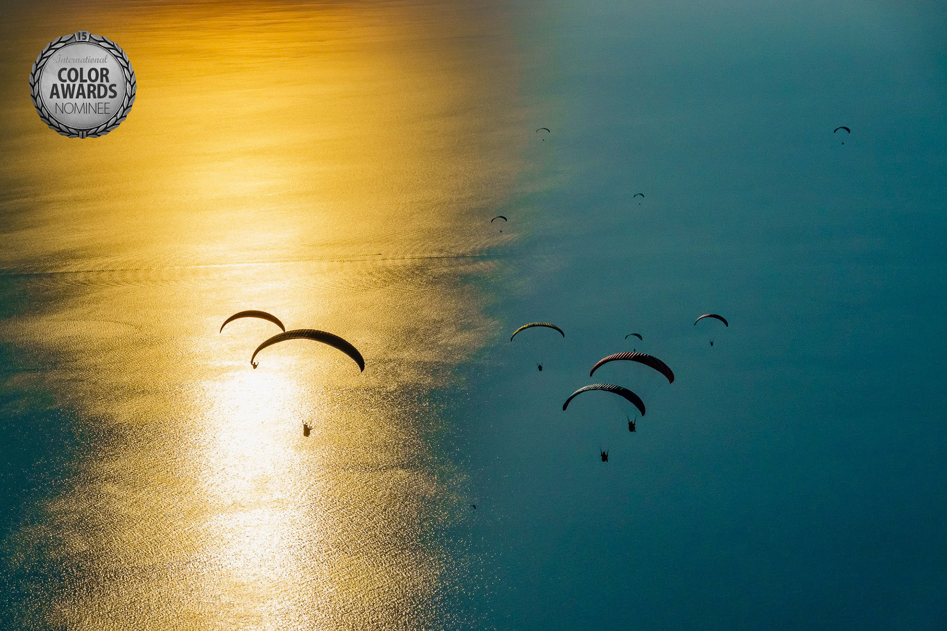 "Fly Away" - Many paragliders gliding away from Babadag in Oludeniz towards the reflection of the setting sun on the Mediterranean.