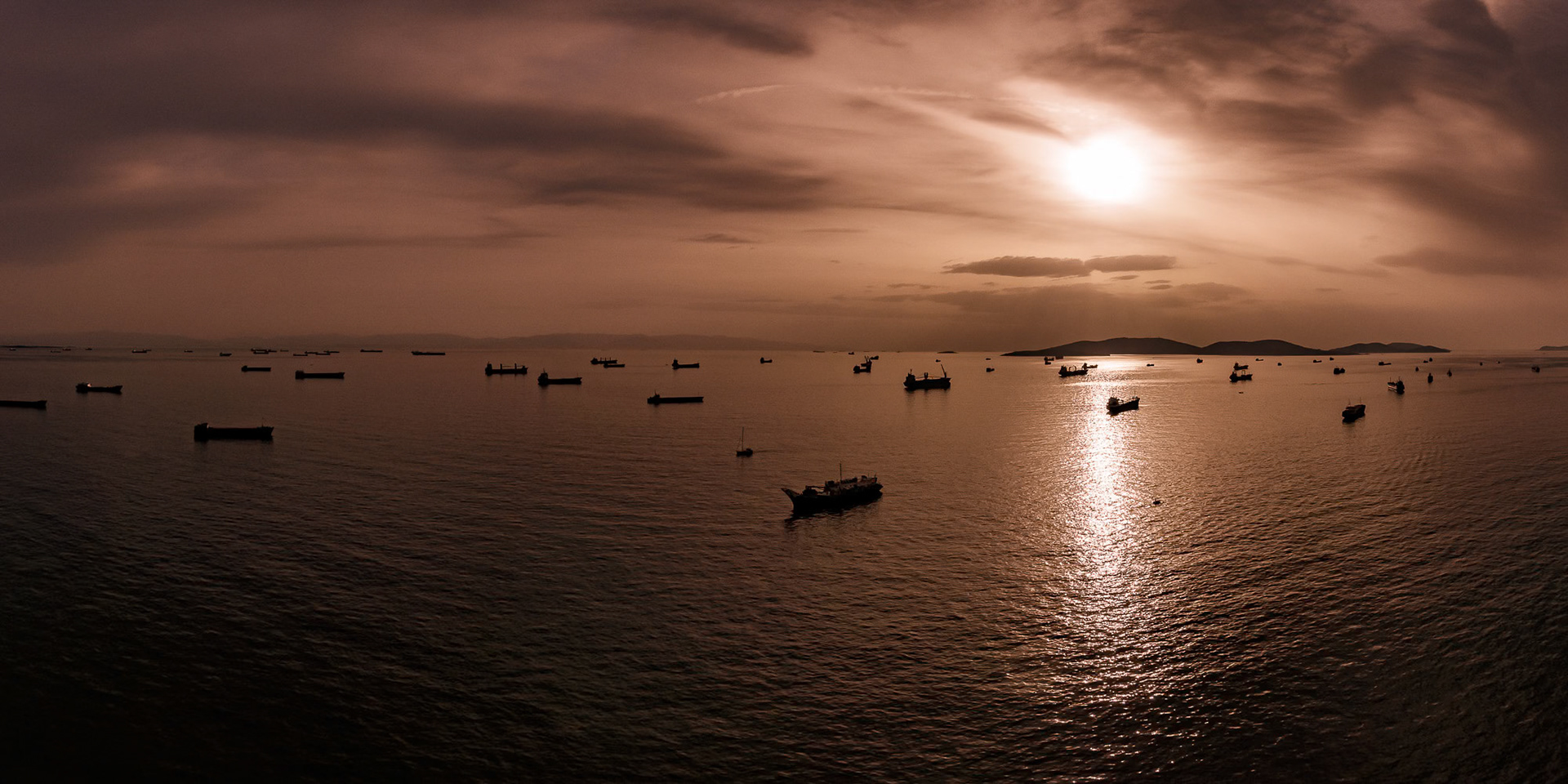 "Silent Meeting" - While flying in my paramotor along the Marmara coast of Istanbul I met with this panorama of ships patiently waiting to enter the Bosphorus in front of the Princes' Islands on a cloudy late winter afternoon.