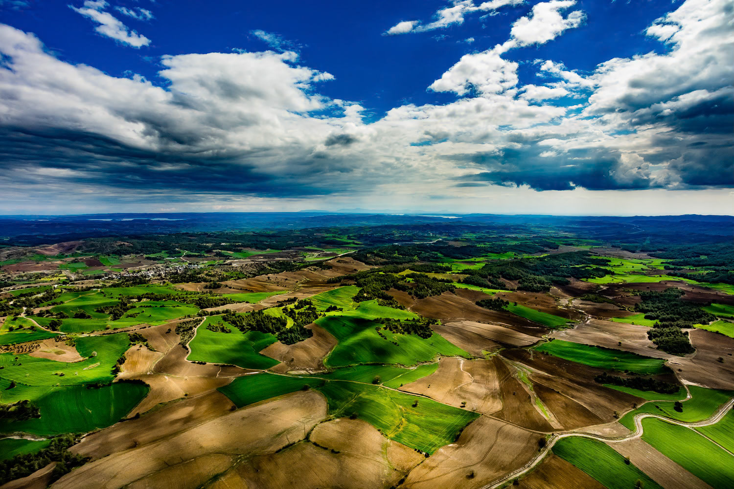 "Karaisali" - Karaisali is a town located 51 km north-northwest from the Adana city center and has been home to various civilizations since it was founded by the Romans. It always attracts tourists with its historical and natural parks. The stunning aesthetic created by the colors of nature in spring preparation, vast Cukurova plain's farmlands and the seasonal clouds that I witnessed during this shoot have made me feel like flying inside a dramatic oil painting.