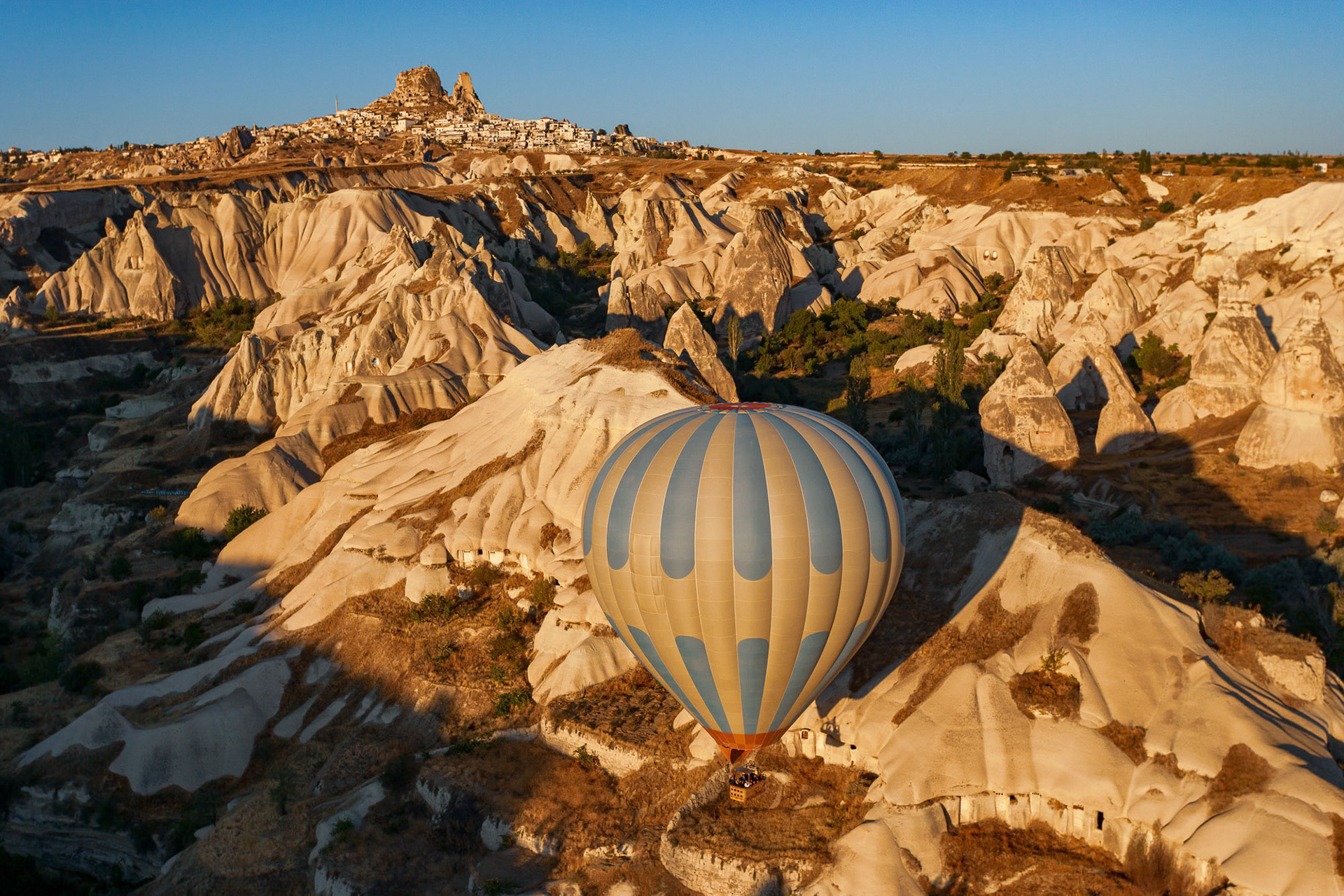 "Cappadocia Encounter" - Hot air balloon meets Uchisar in magical Cappadocia. I shot the aerial photograph from my paramotor in the land of the fairy chimneys, cave dwellings, intricate valleys and underground cities.