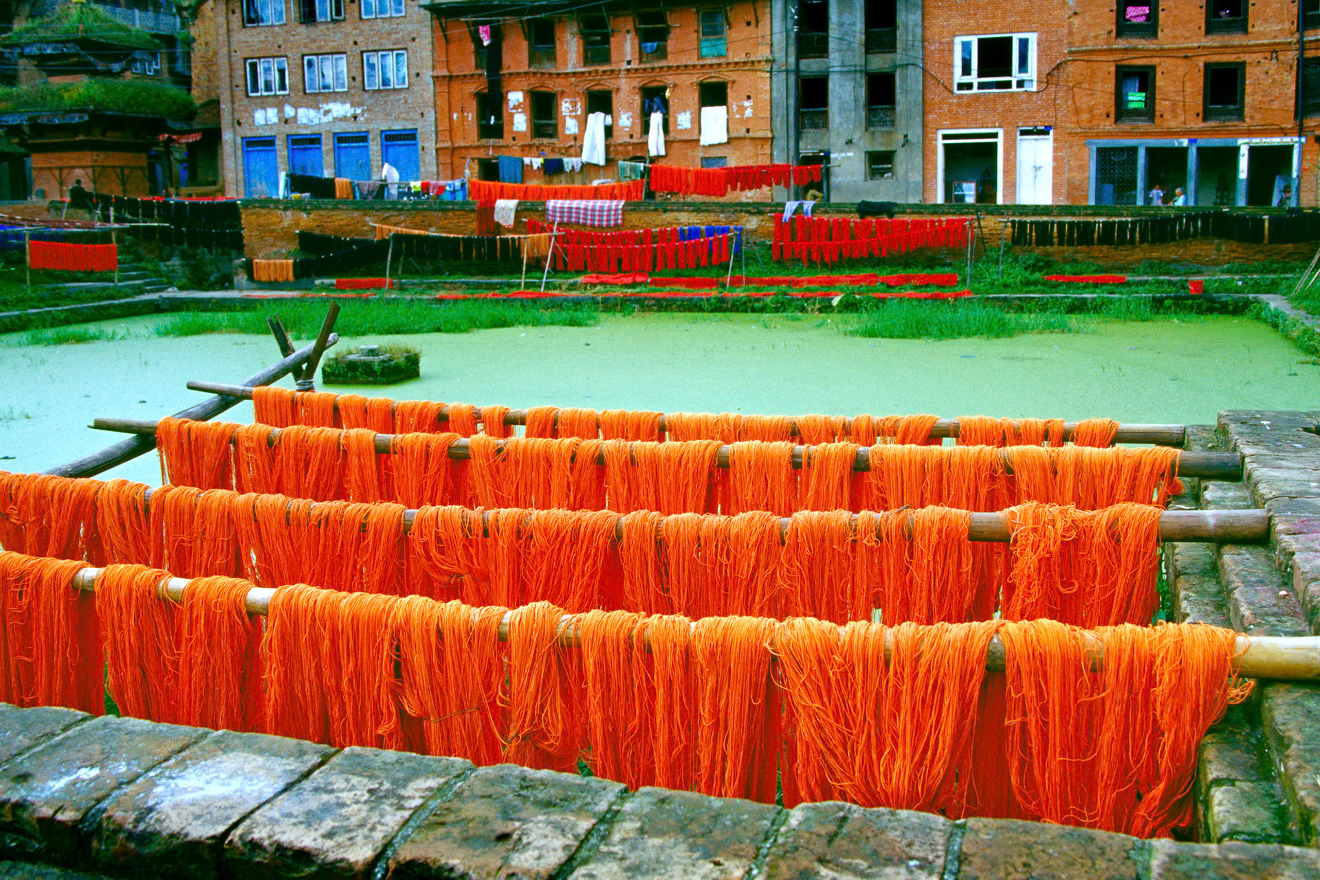 "Bhaktapur" - The strong warm colors of yarn hung to be dried and the green color of the water make a nice contrast in this photograph which I took in Bhaktapur, Nepal.